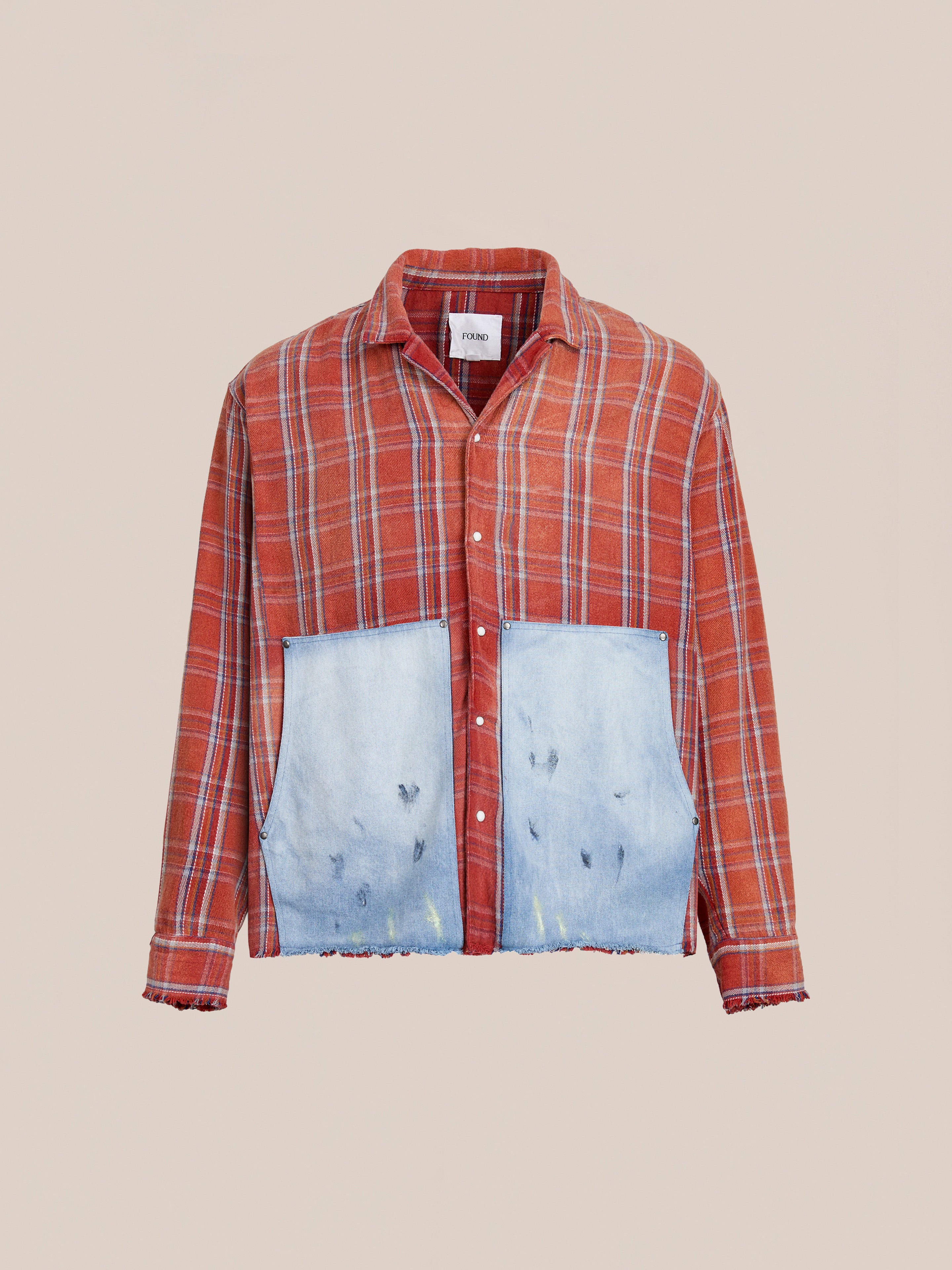 The FOUND Plaid Denim Shirt features a red plaid design, frayed edges, and large front denim carpenter pockets for a stylish unisex relaxed fit.
