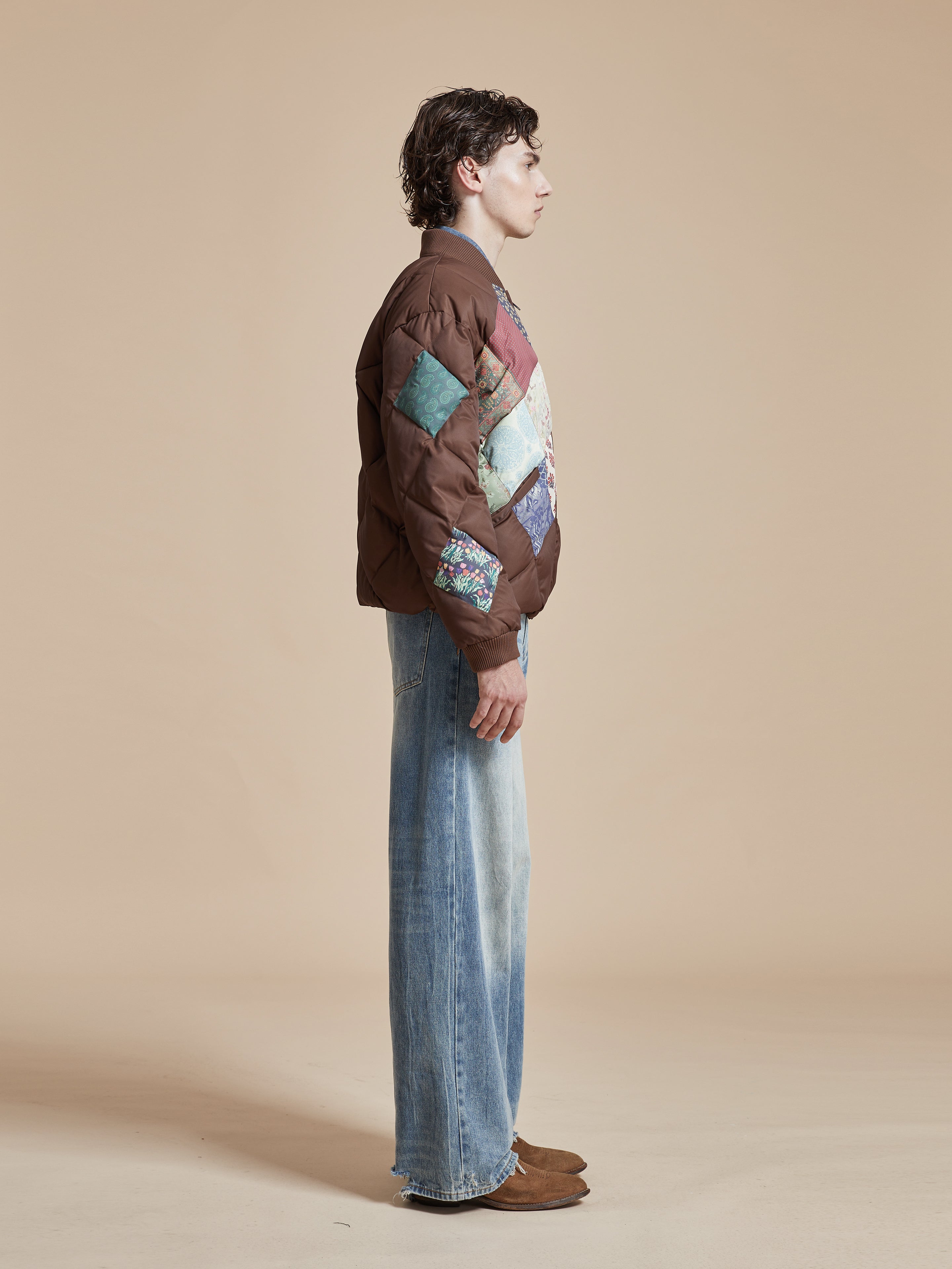 A man in a Found Diamond Quilt Patchwork Jacket.