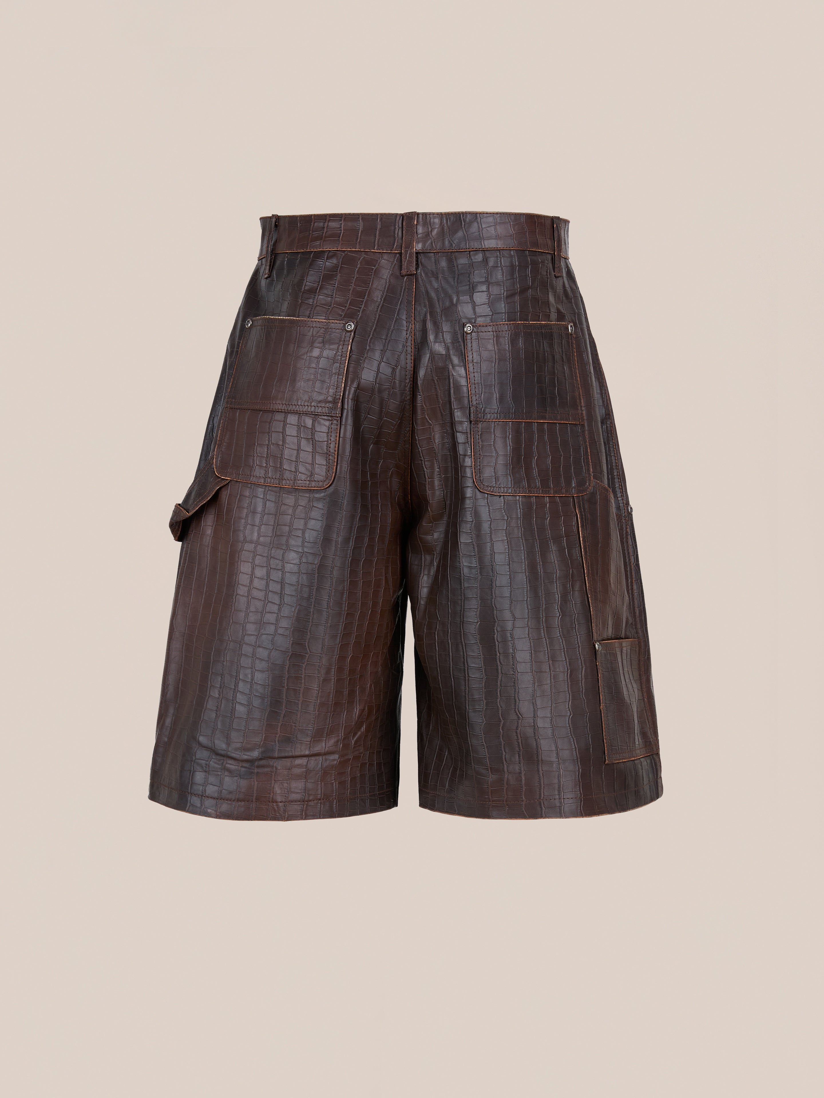 FOUND Distressed Croc Embossed Leather Shorts with multiple large patch pockets, shown on a plain beige background.