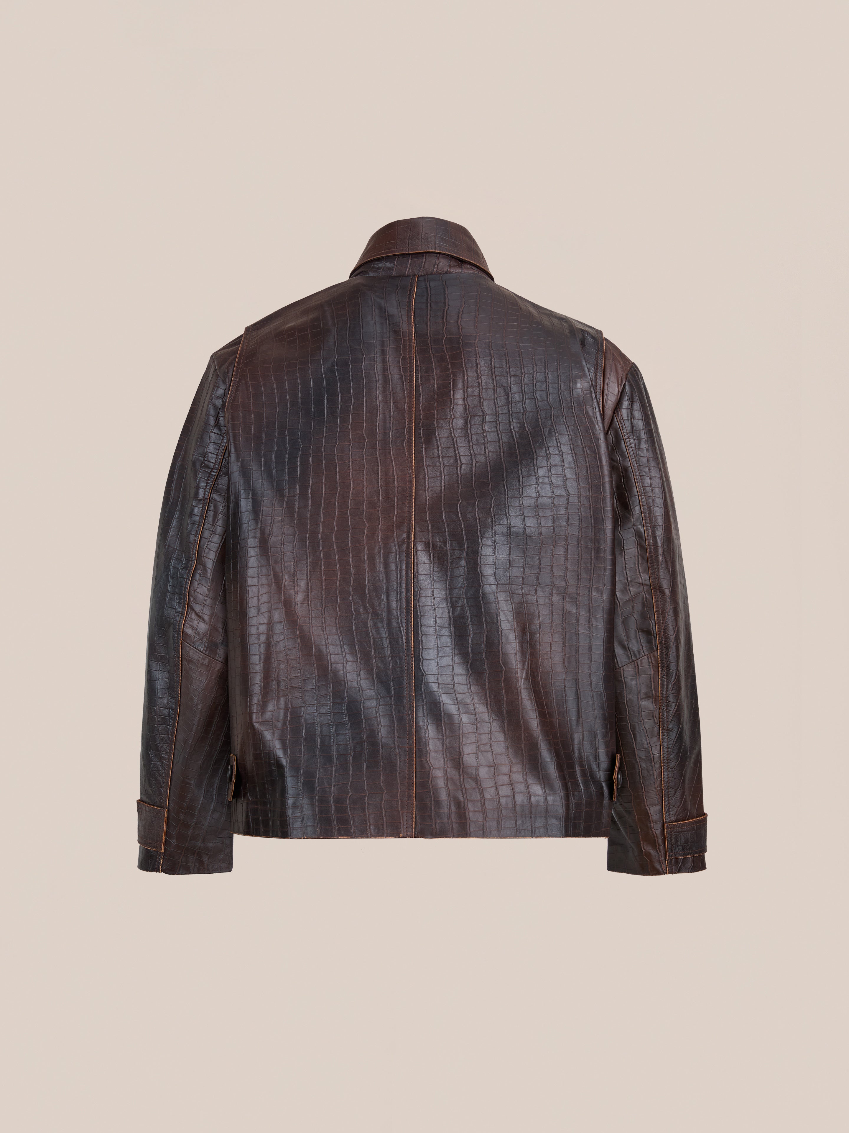 The FOUND Distressed Croc Embossed Leather Work Jacket is shown from the back on a neutral background, featuring visible stitching and a classic collar.
