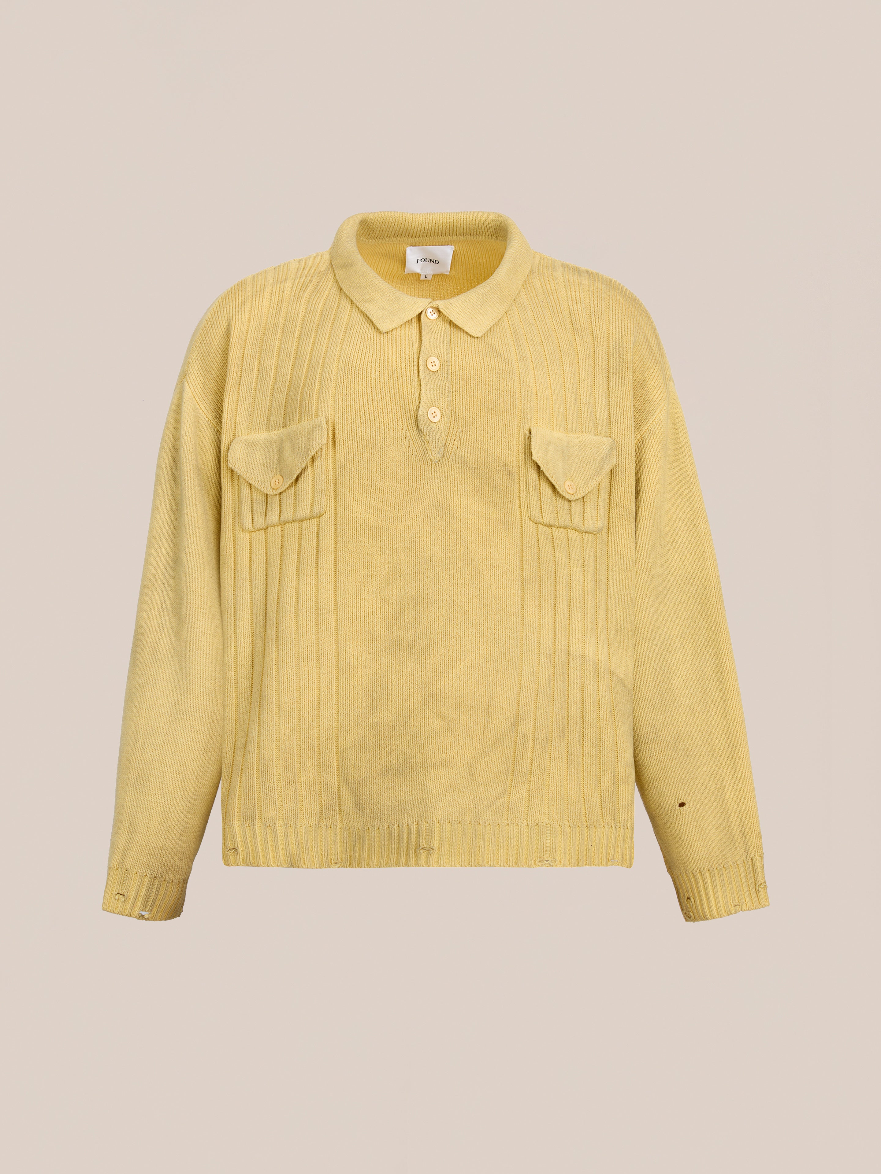 The FOUND Distressed Pullover Knit is a light yellow, unisex relaxed fit sweater with long sleeves, a polo collar, three front buttons, and two chest pockets shown against a plain background.