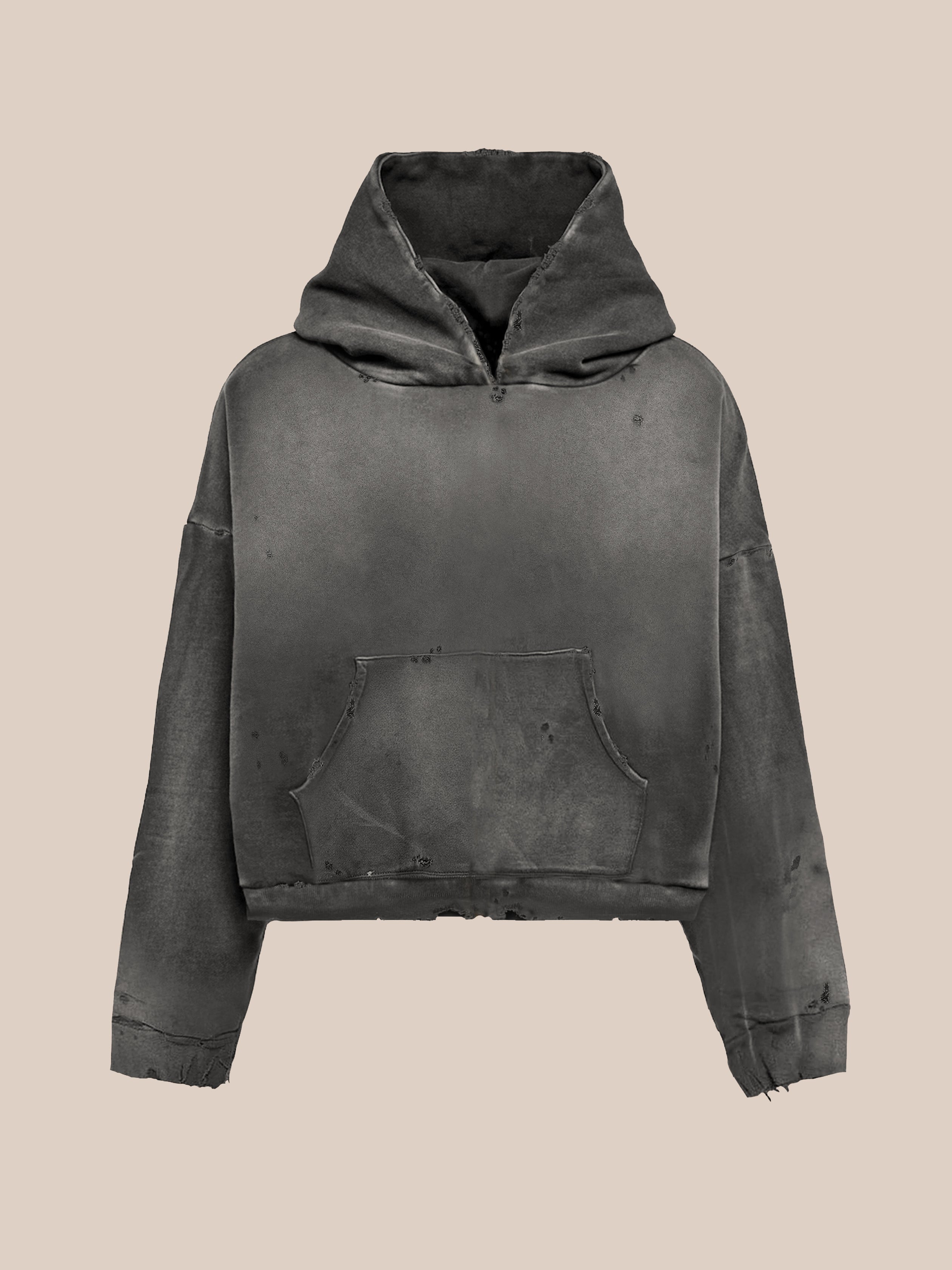 The FOUND Distressed Pullover Hoodie features a vintage black look, unisex relaxed and oversized fit, large front pocket, and visible distressed cuffs and hem, shown against a plain beige background.