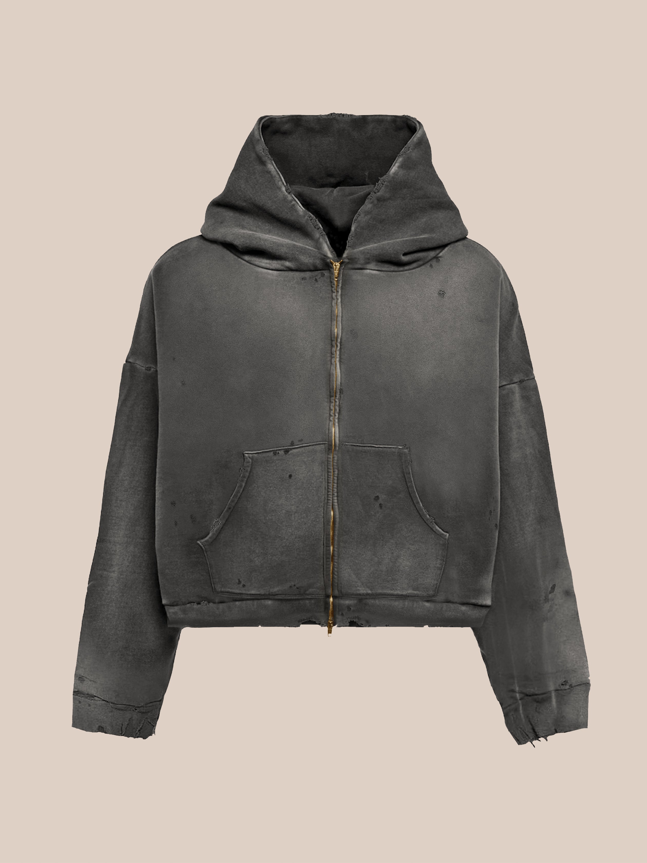 The FOUND Distressed Thermal Lined Zip Up Hoodie in dark gray features a unisex relaxed fit, front pocket, visible wear, and frayed edges. Shown on a plain beige background.