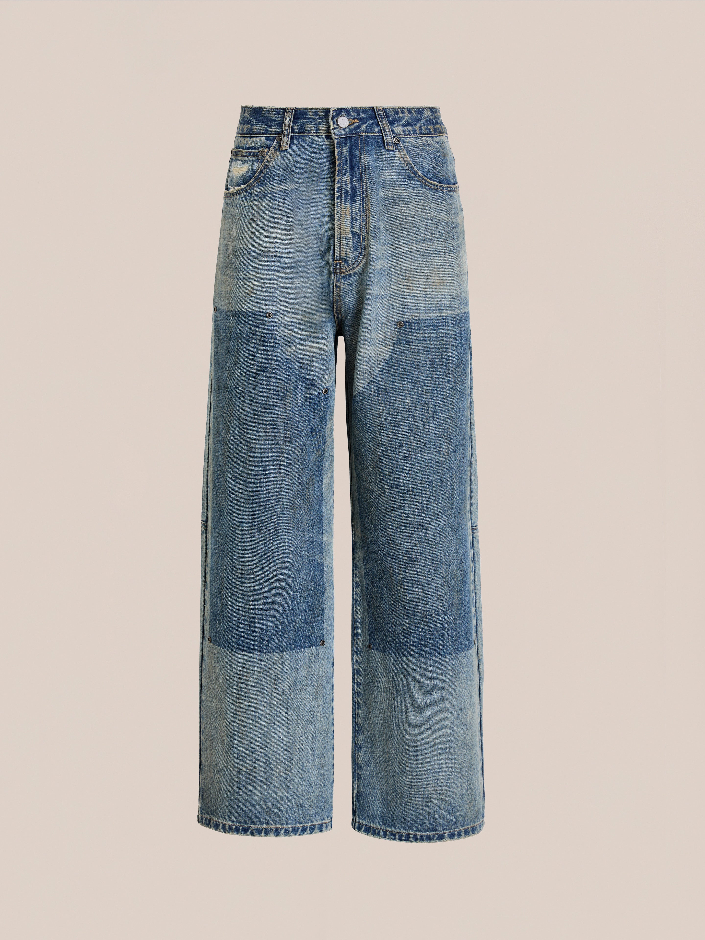 FOUND's Double Knee Carpenter Jeans feature a wide-leg relaxed fit, vintage wash, dark denim patches on the thighs and knees, front pockets, belt loops, and a button closure, shown against a plain beige background.