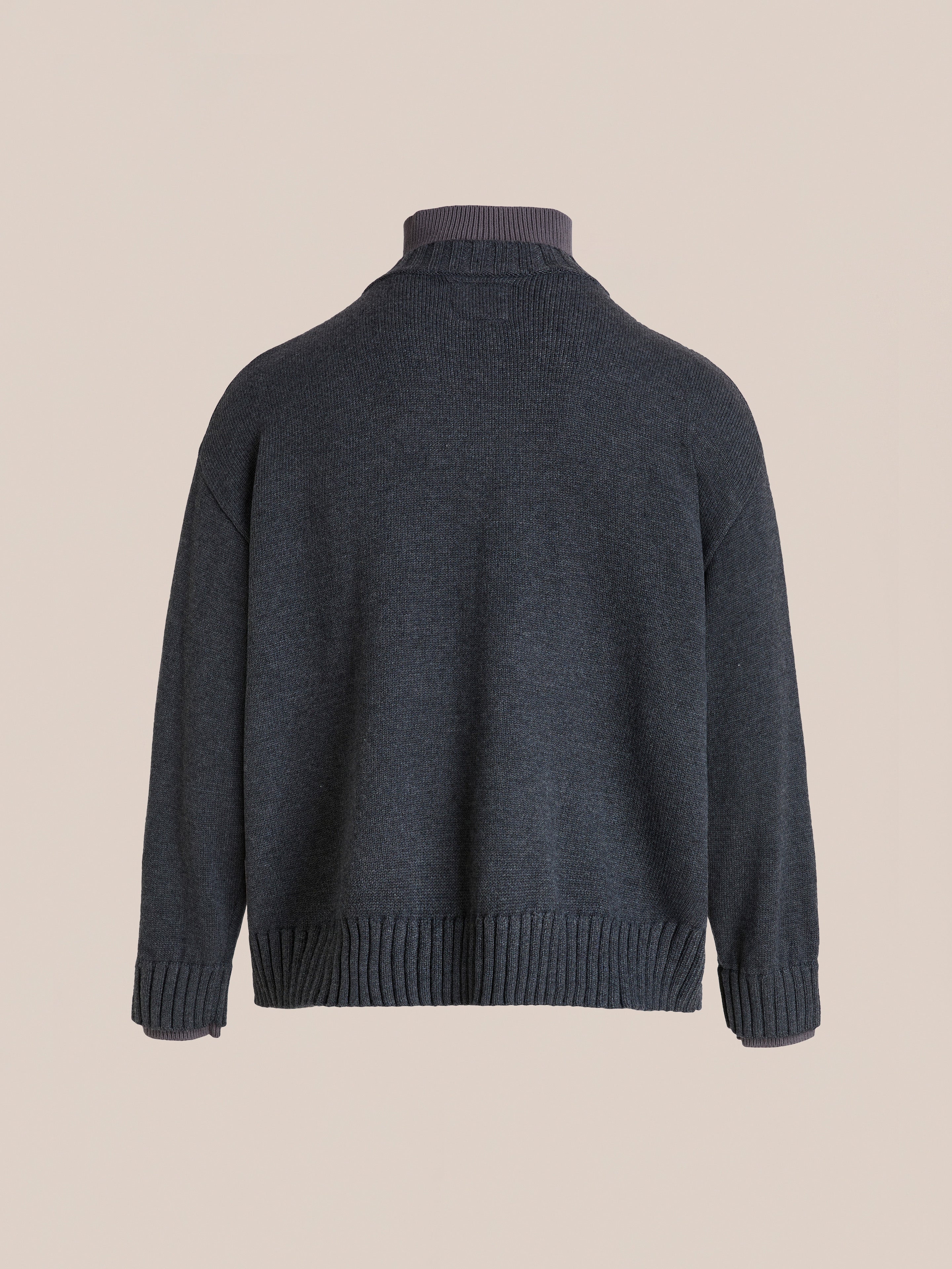 The FOUND Double Layer Sweater, in a charcoal wool blend, features a V-neck, folded collar, and ribbed cuffs and hem, shown against a plain beige background.