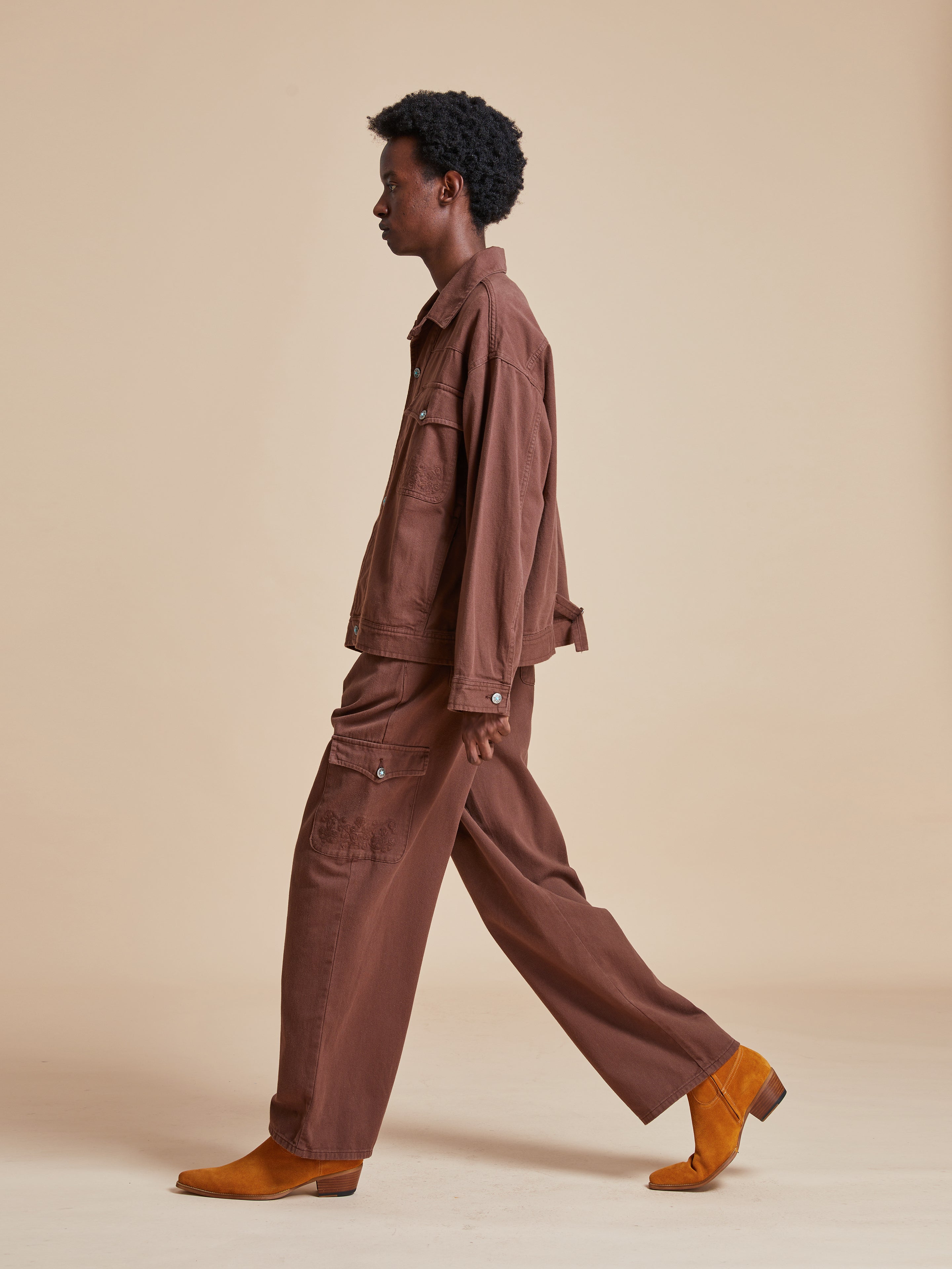 The model is wearing a Dusky Western Trucker Jacket and brown boots by Found.