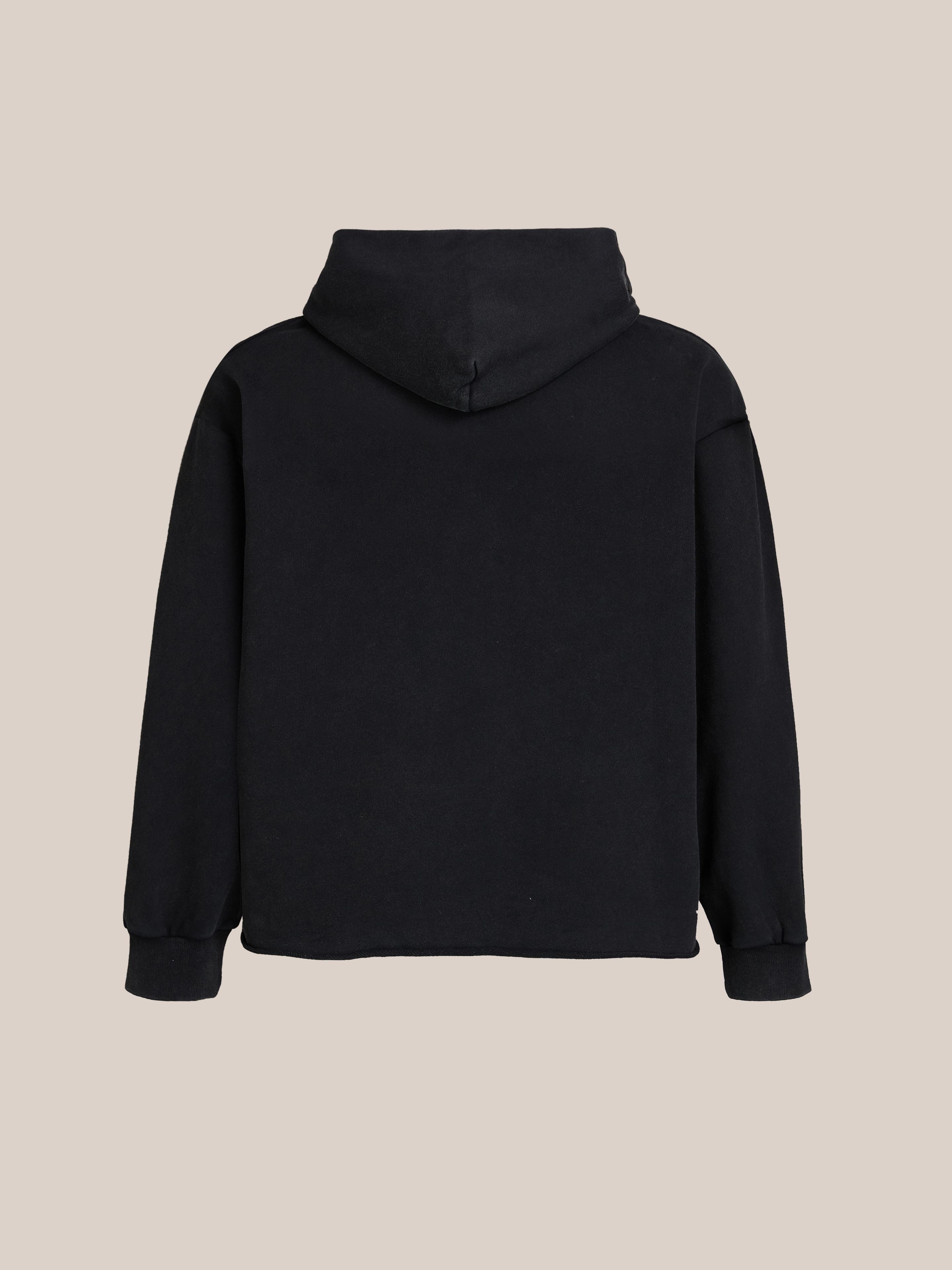 A plain black FOUND Bouquet Flowers Hoodie is displayed from the back against a beige background.