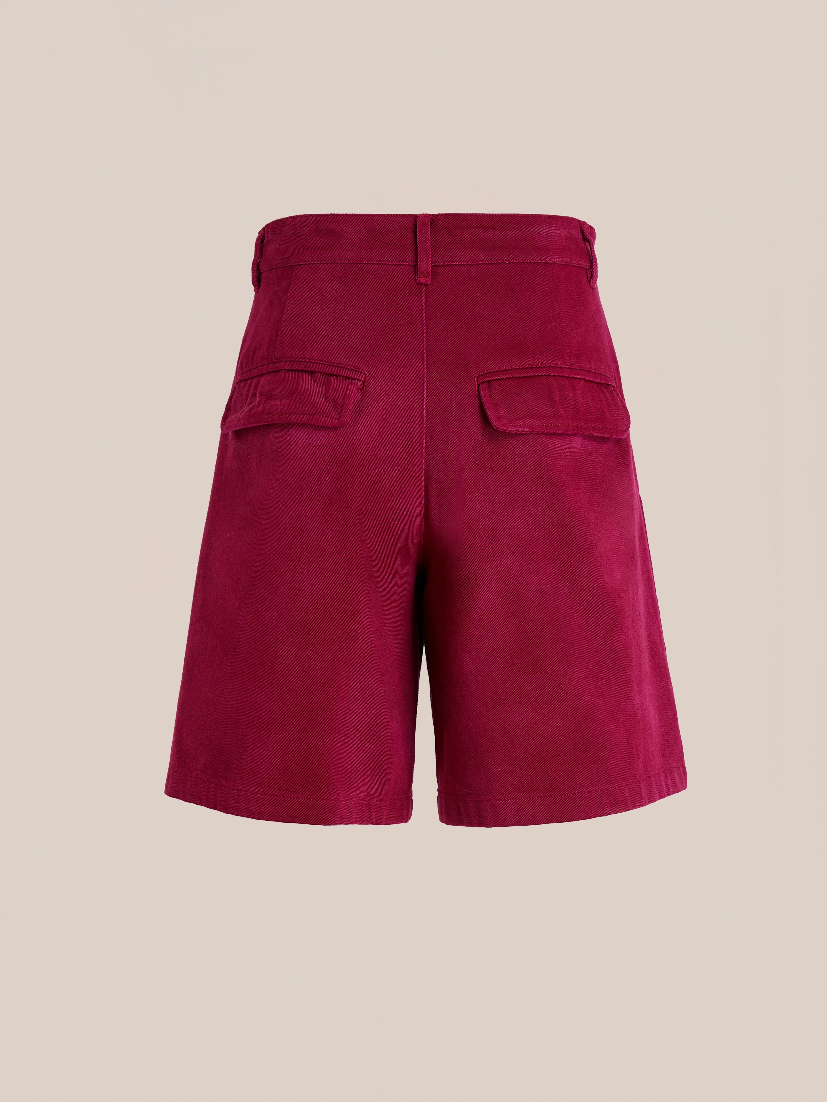 Back view of Found's Embroidered Duck Shorts in vintage maroon cotton canvas with two flap pockets, shown on a plain beige background.
