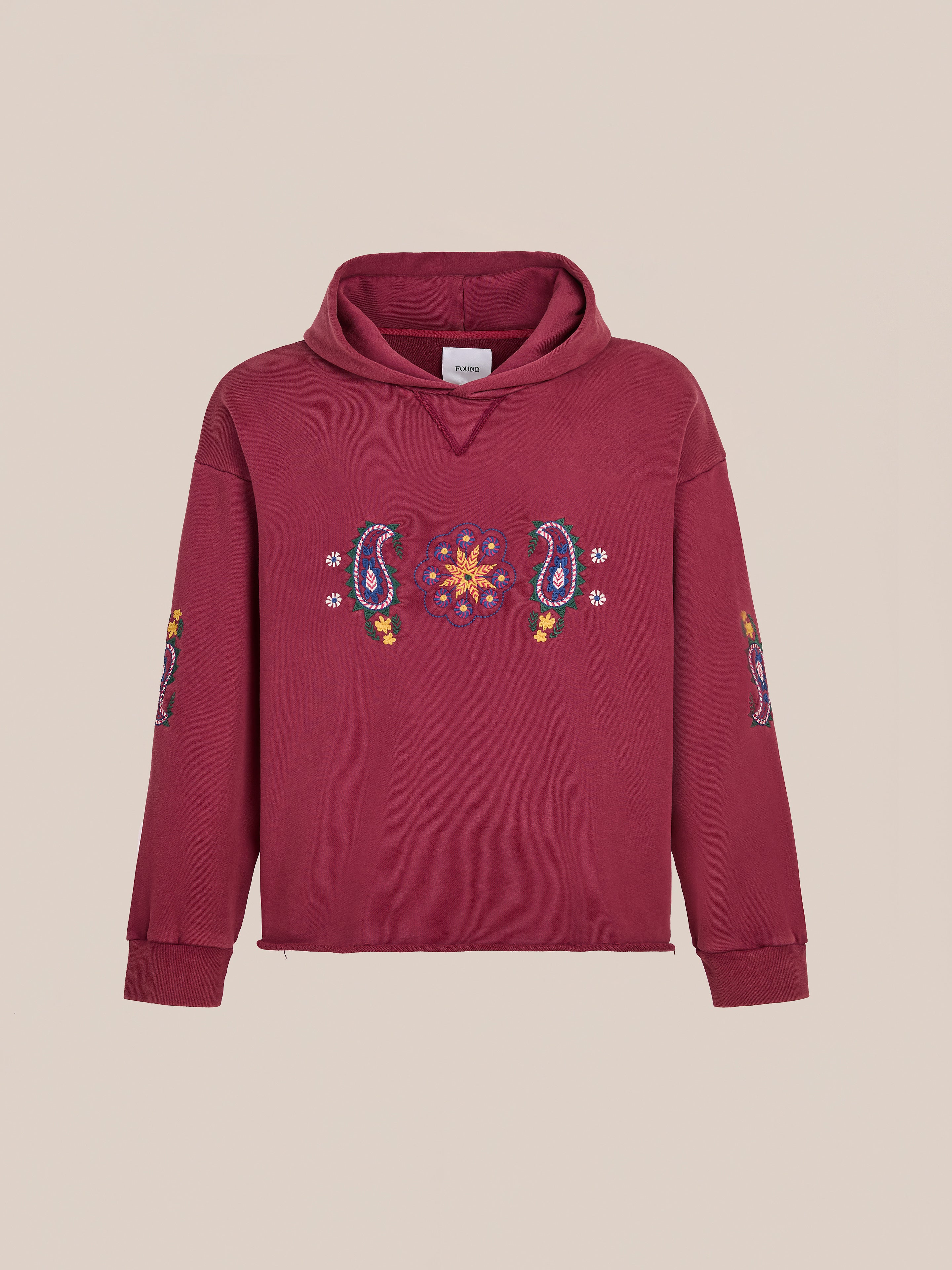 FOUND Embroidered Kantha Paisley Hoodie in maroon cotton fleece with a unisex relaxed fit features paisley and floral embroidery on chest and sleeves, shown on a plain beige background.