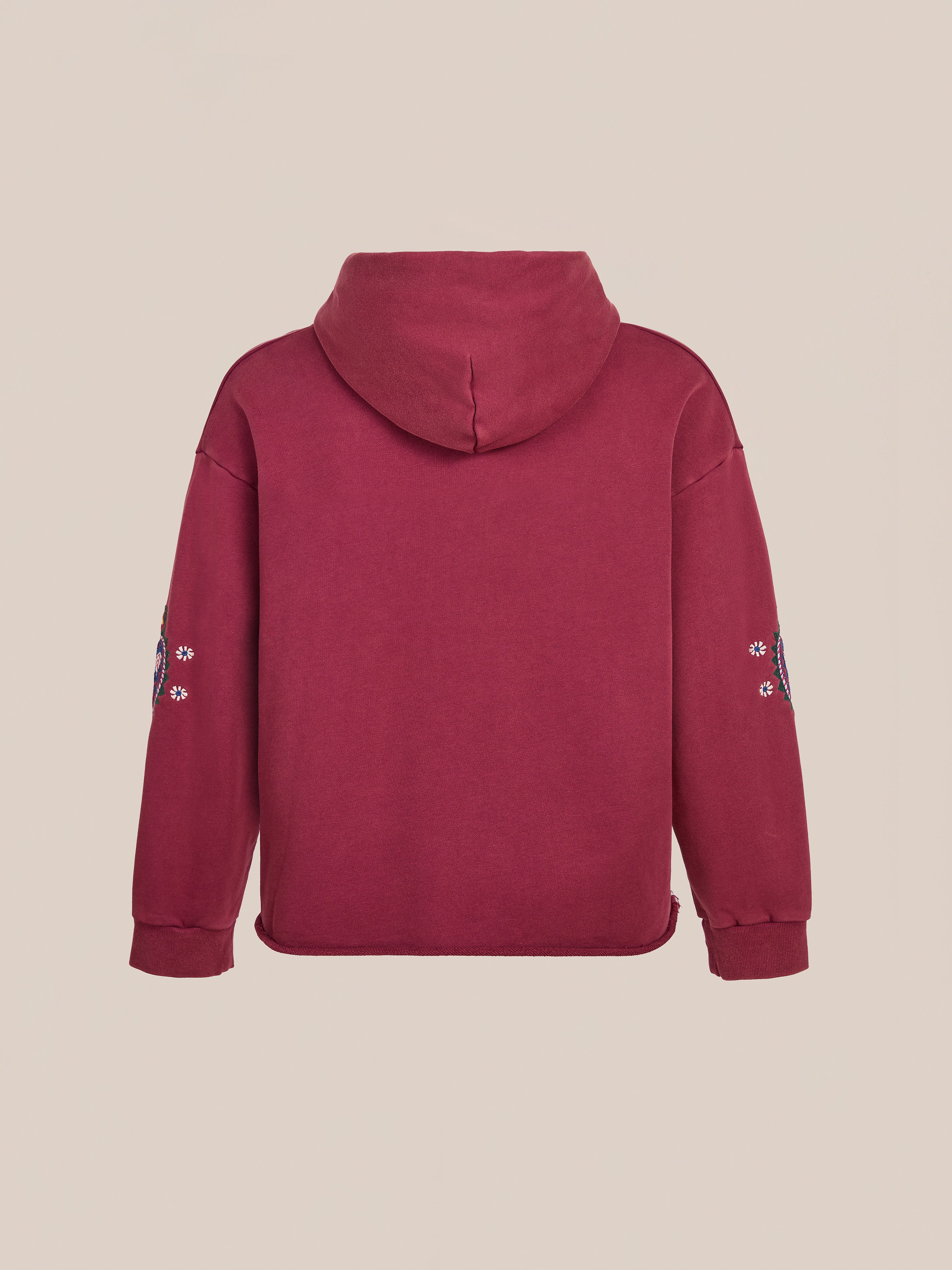Back view of the FOUND Embroidered Kantha Paisley Hoodie, a unisex relaxed fit maroon cotton fleece piece with Kantha-inspired paisley embroidery on the sleeves, shown against a plain beige background.