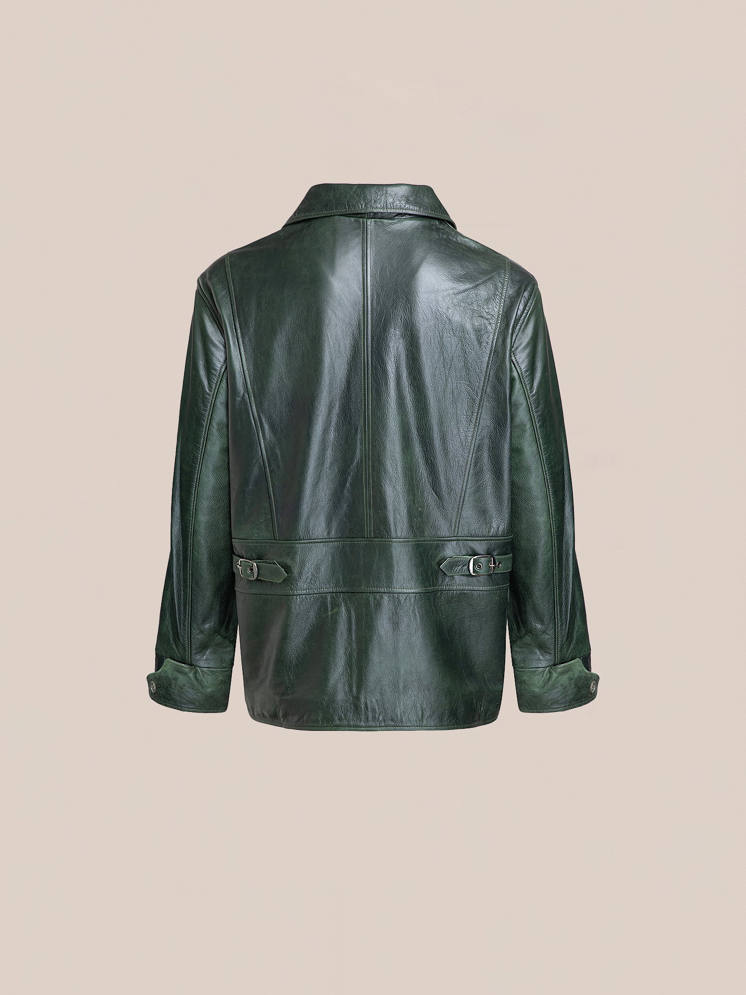The FOUND Leather Field Jacket in emerald green hand-distressed leather, featuring a collar, long sleeves, and adjustable waist and cuff straps, is shown from the back against a plain beige background.