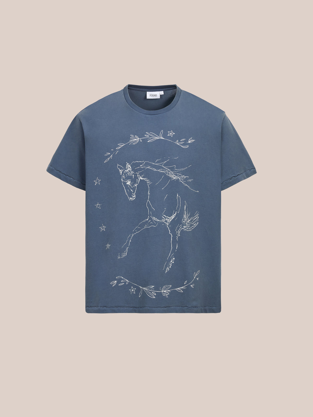 The Faded Horse Trot Tee by FOUND is a unisex relaxed fit with an equestrian graphic of a horse, stars, and leaves on the front, set against a beige background.