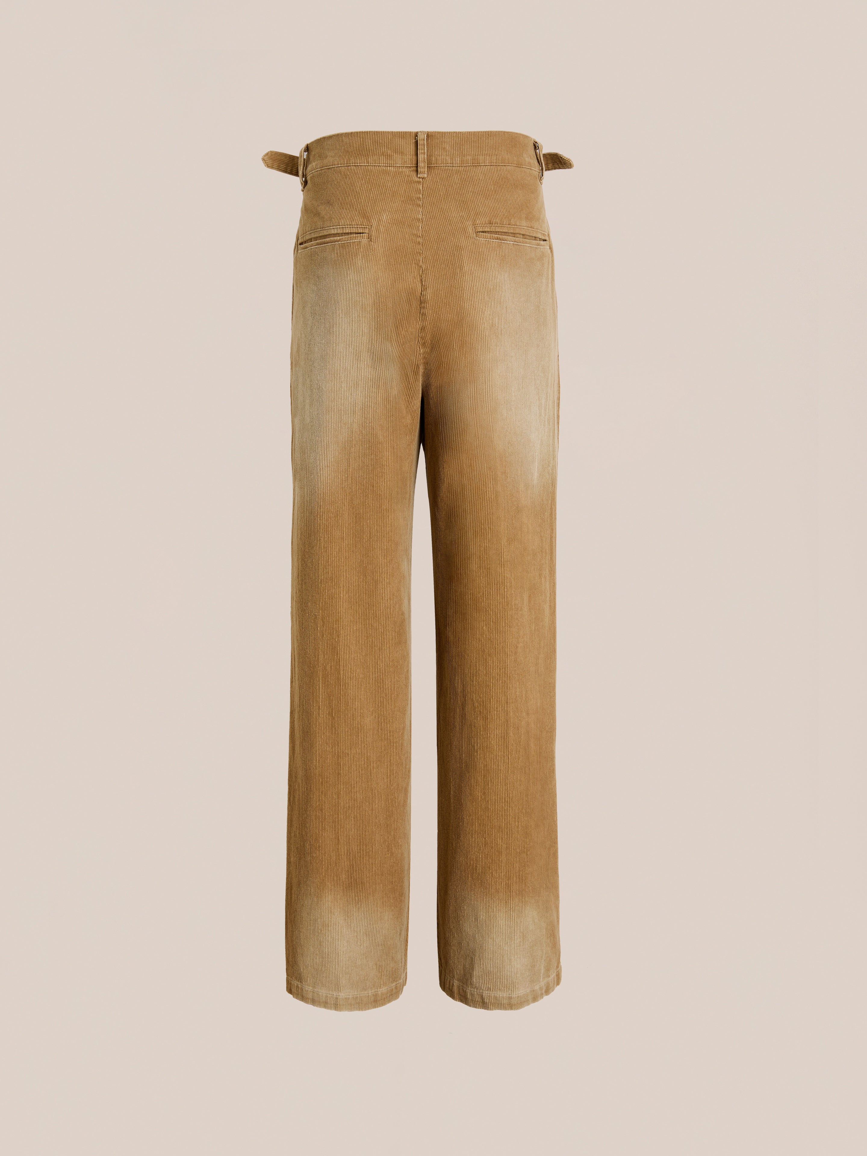Back view of FOUND Faded Pleated Corduroy Pants in beige, featuring double pleats, adjustable side tabs, two rear welt pockets, and a relaxed fit, shown against a plain background.