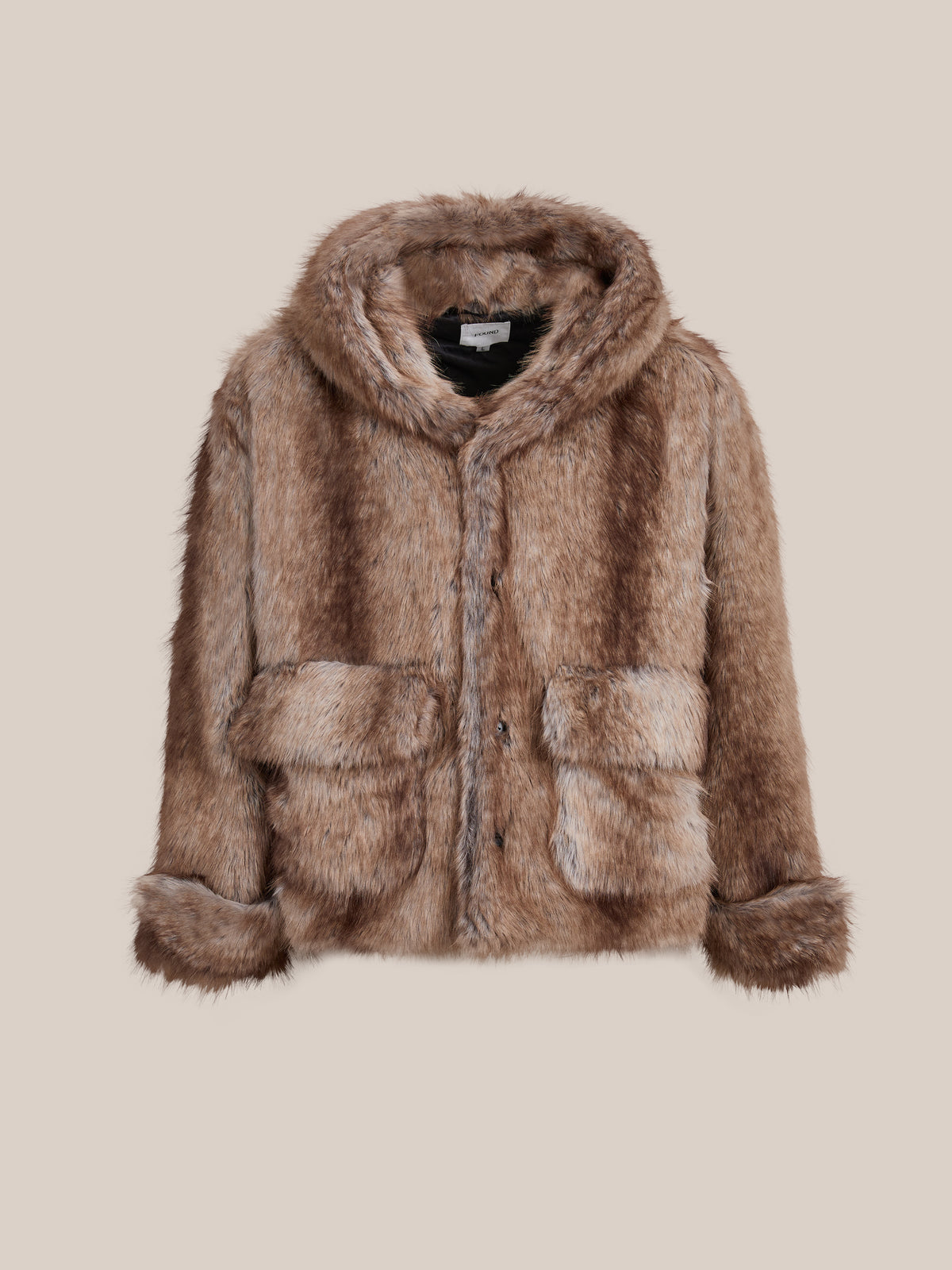 FOUND Faux Fur Hoodie: a brown unisex winter jacket with front buttons and large pockets, shown against a beige background.