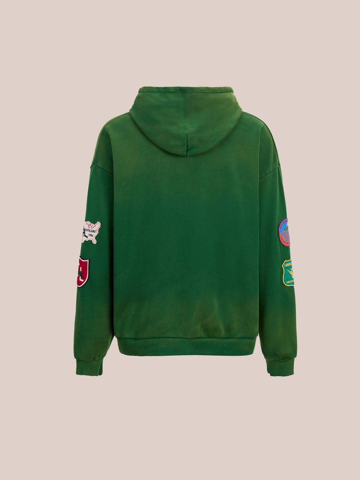 Found Logo Patch Hoodie by FOUND shown from the back with colorful sleeve patches and a unisex relaxed fit, set against a plain beige background.
