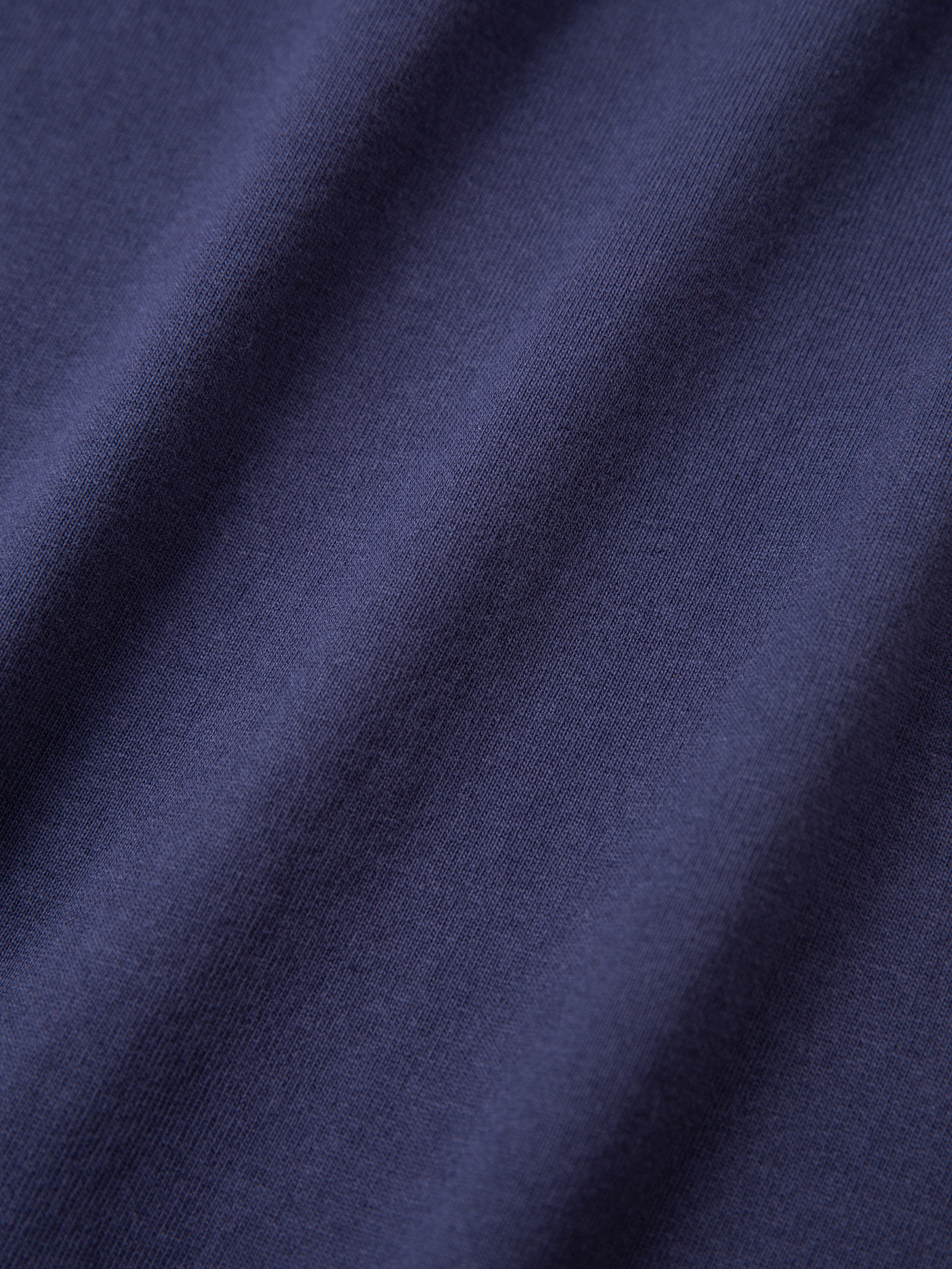 Close-up of the Horse Equine Tee by FOUND, showcasing its dark blue fabric texture and weave.