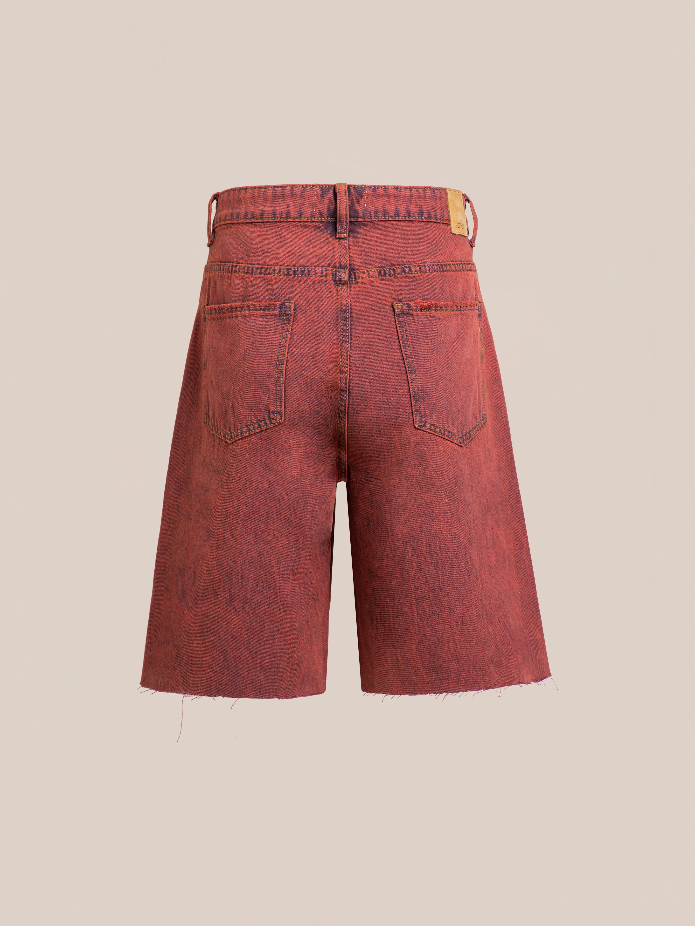 FOUND Lacy Jean Jorts in vintage red wash, shown from the back with two rear pockets, belt loops, raw cut hems, and a leather waistband patch. Made from 100% cotton denim for classic comfort and style.