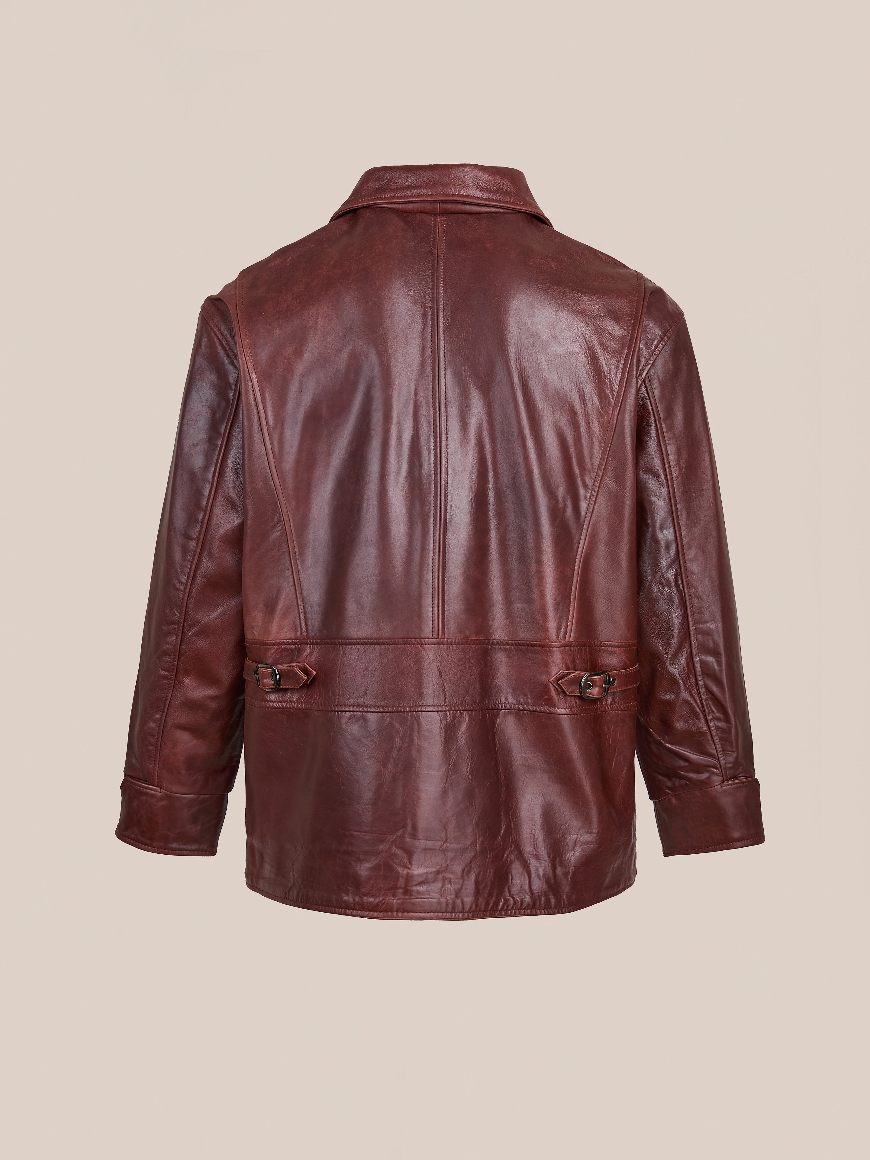 The FOUND Leather Field Jacket is a unisex, relaxed fit brown leather jacket with adjustable side buckles and a straight hem, shown from the back against a plain light background.