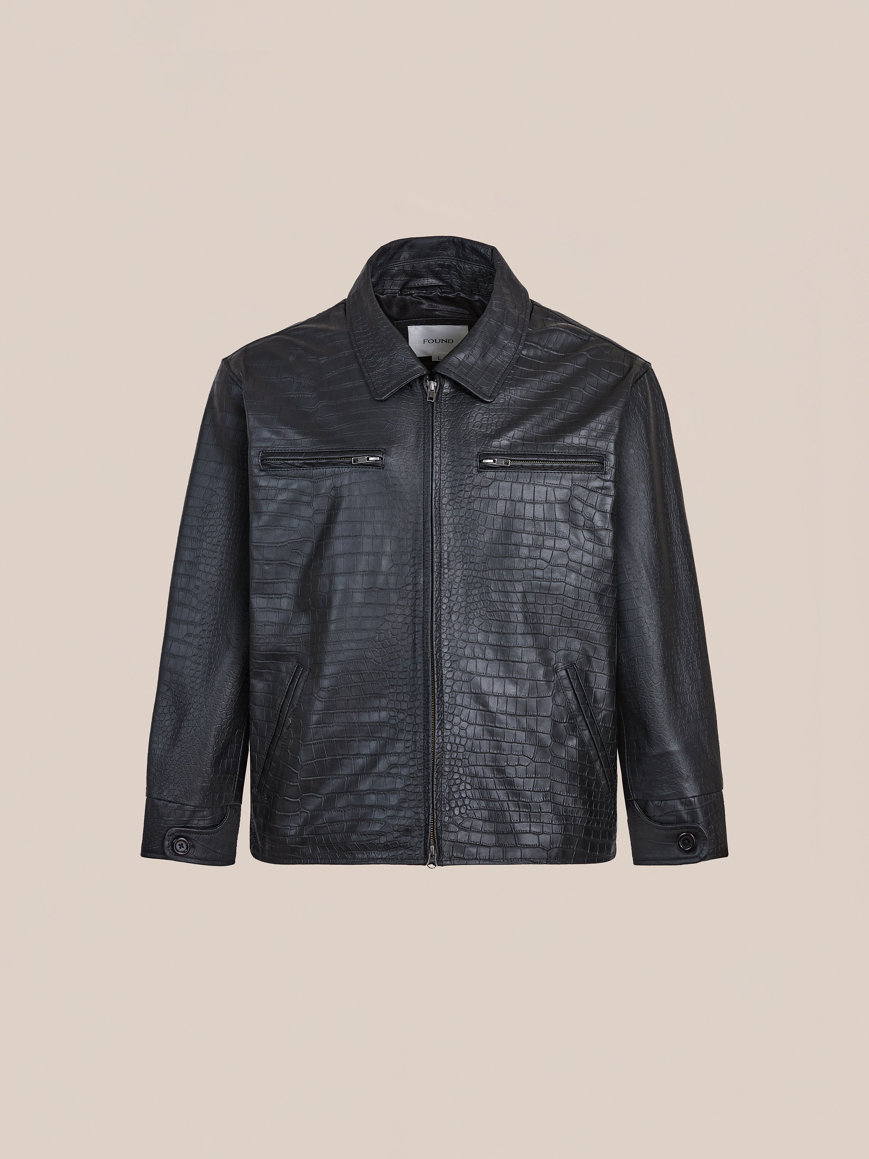 The FOUND Marlboro Croc Embossed Leather Racer Jacket features a sleek racing silhouette, subtle crocodile texture, front zipper, two zippered chest pockets, and buttoned cuffs, shown on a plain beige background.