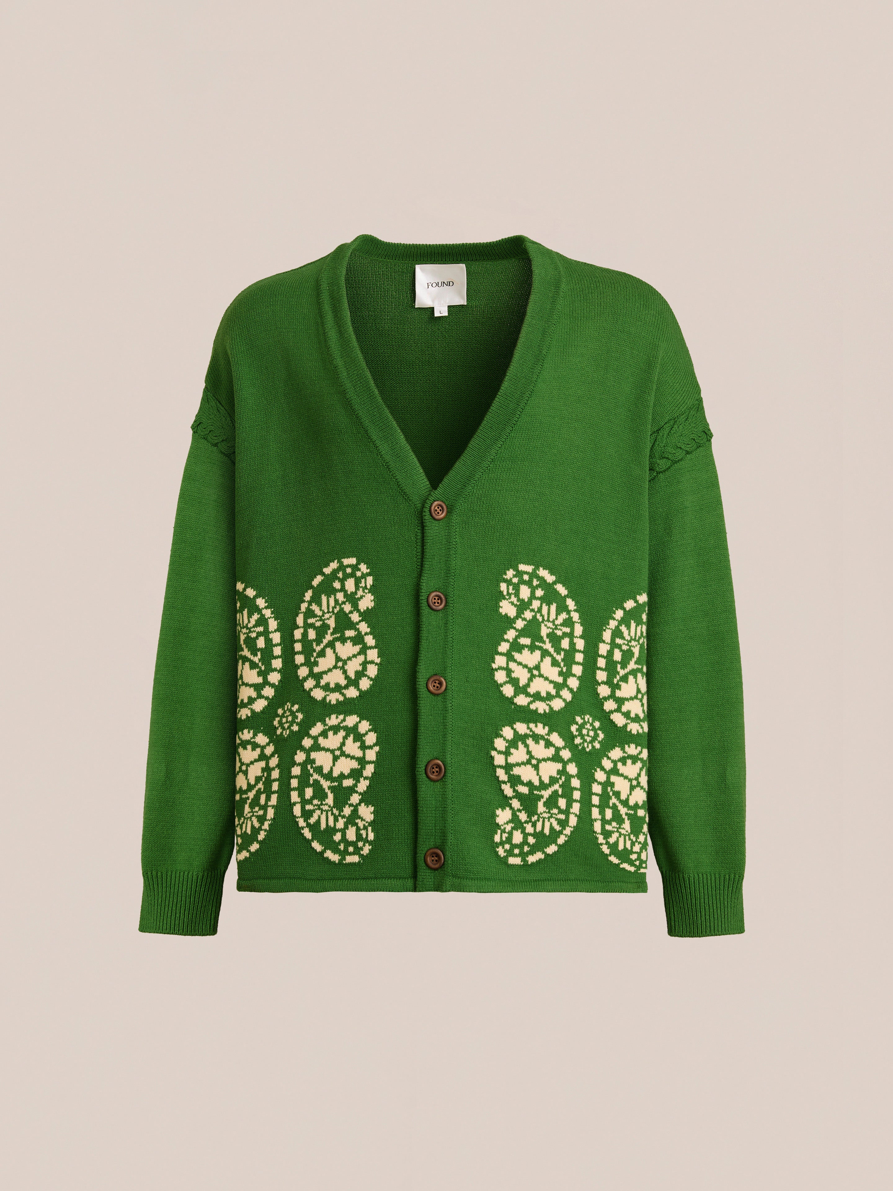 The FOUND Paisley Knit Cardigan is a green cotton V-neck piece featuring beige floral patterns on the lower front. Displayed against a plain background, this unisex cardigan blends comfort and style for any wardrobe.