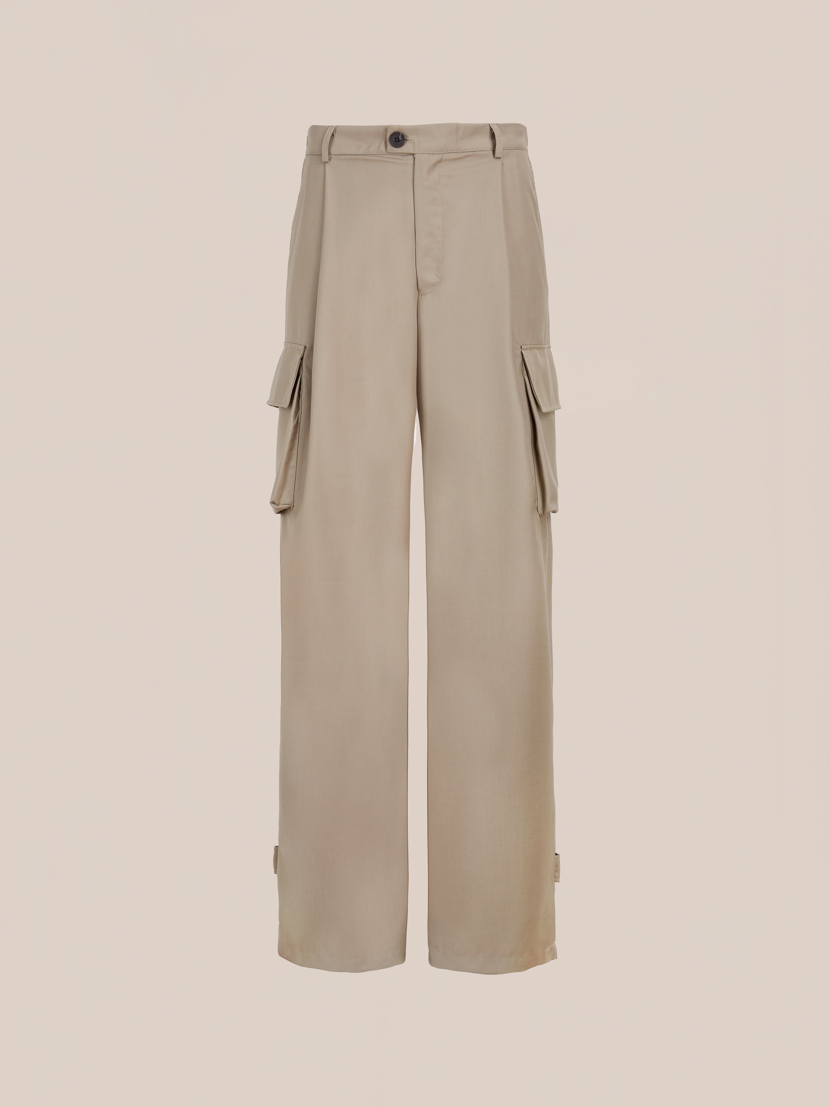 FOUND Pleated Cargo Pants in beige feature a high waist, relaxed fit, wide legs, side flap pockets, and front button-zip closure, displayed on a plain background.