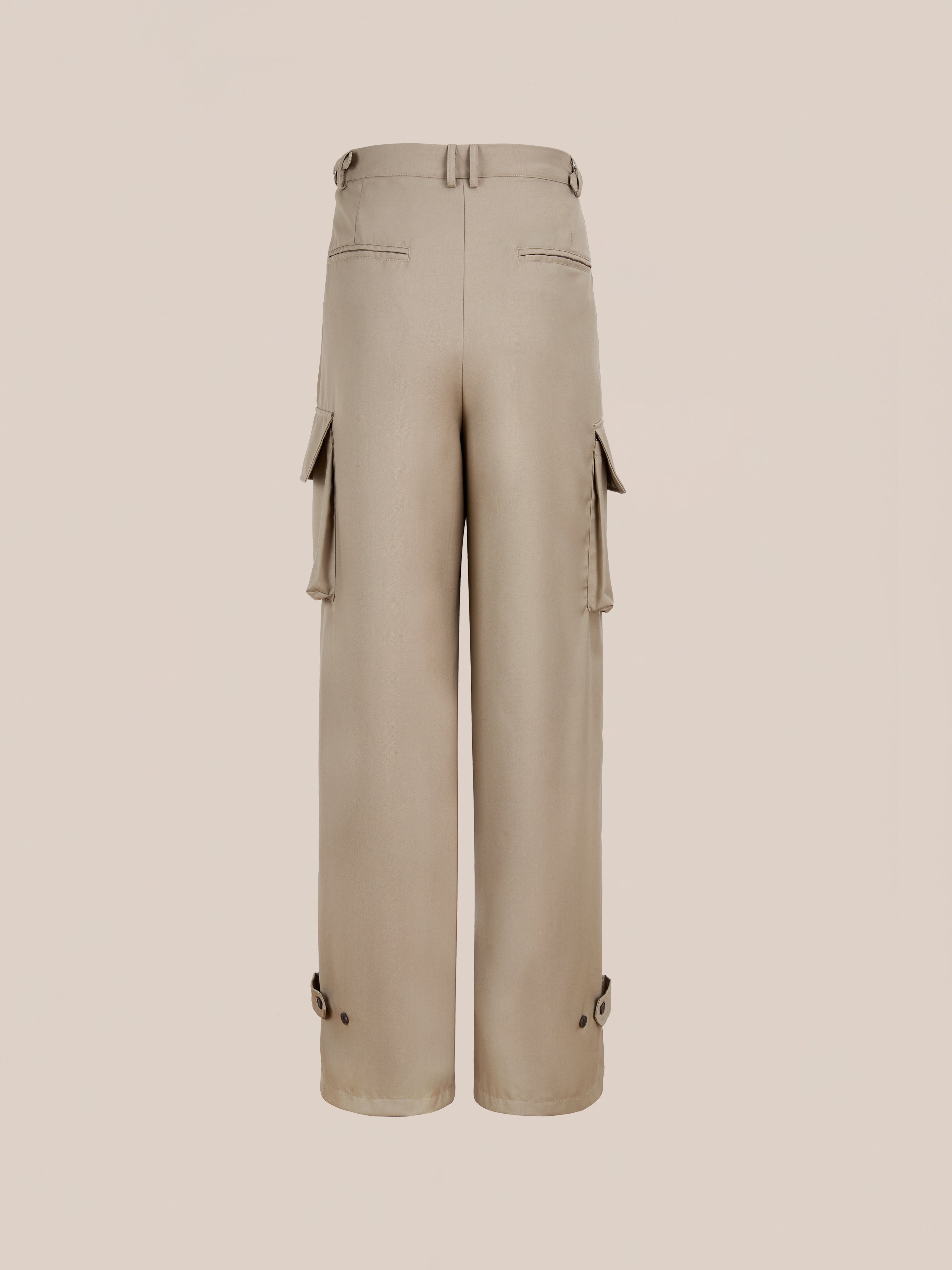 FOUND Pleated Cargo Pants in beige, featuring a relaxed fit, wide legs, side and back pockets, belt loops, lower leg button details—shown against a plain background.