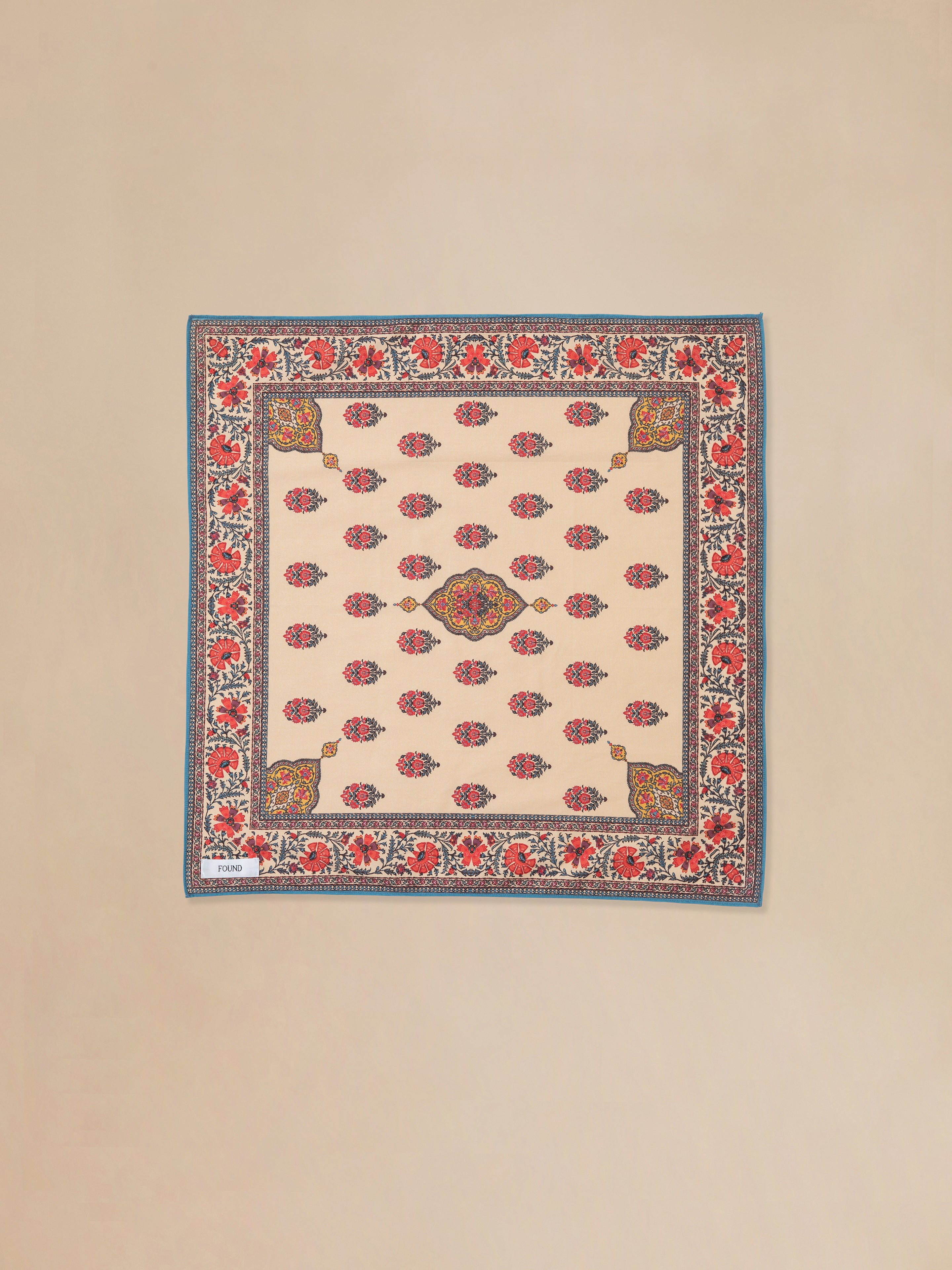 A beige and red Poinciana Bandana rug with an Indo-Aryan floral pattern by Found.