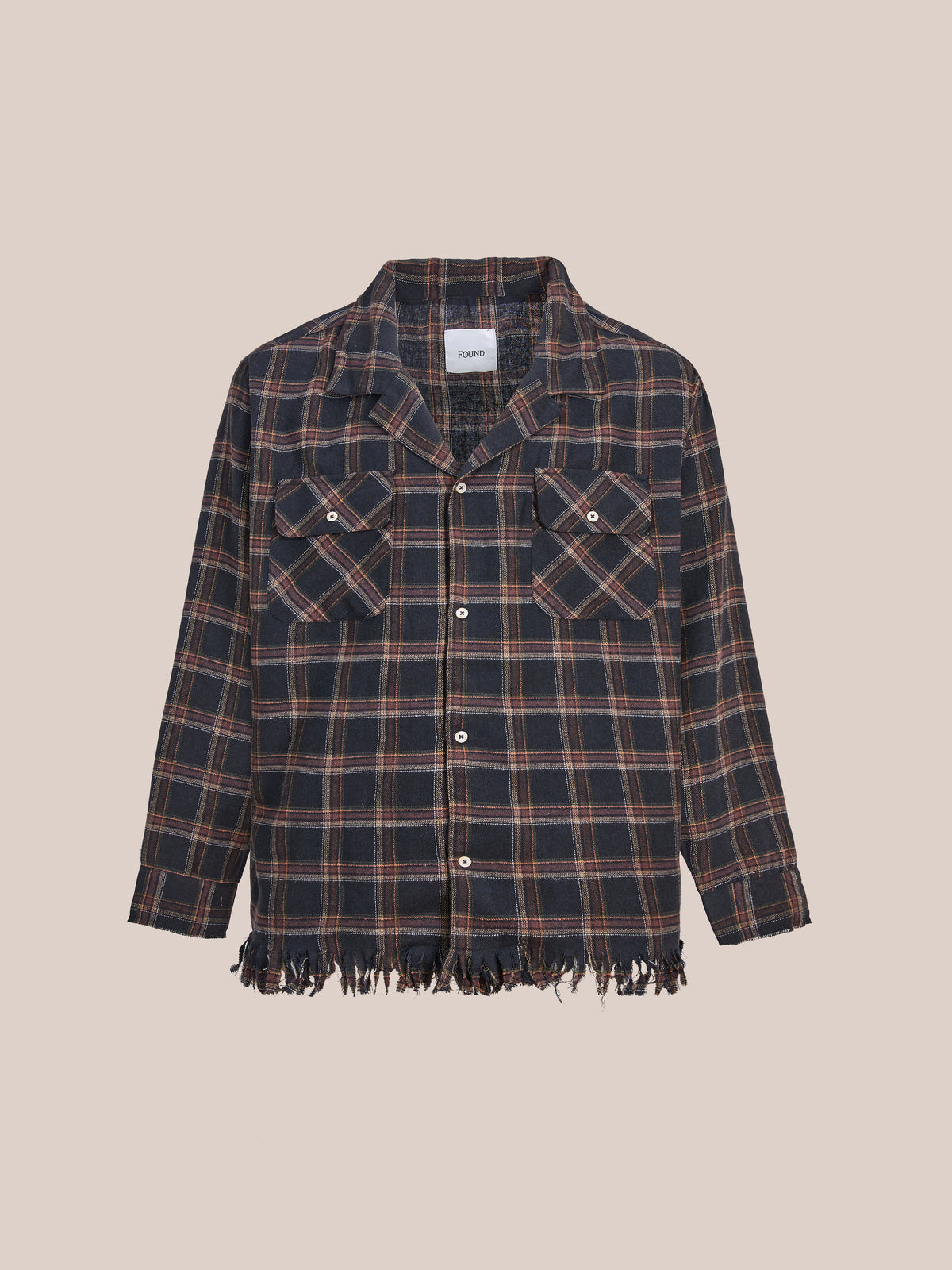 The FOUND Raw Cut Fringe Plaid Camp Shirt features long sleeves, black and brown plaid, chest pockets, and a raw cut fringe hem against a plain light background.