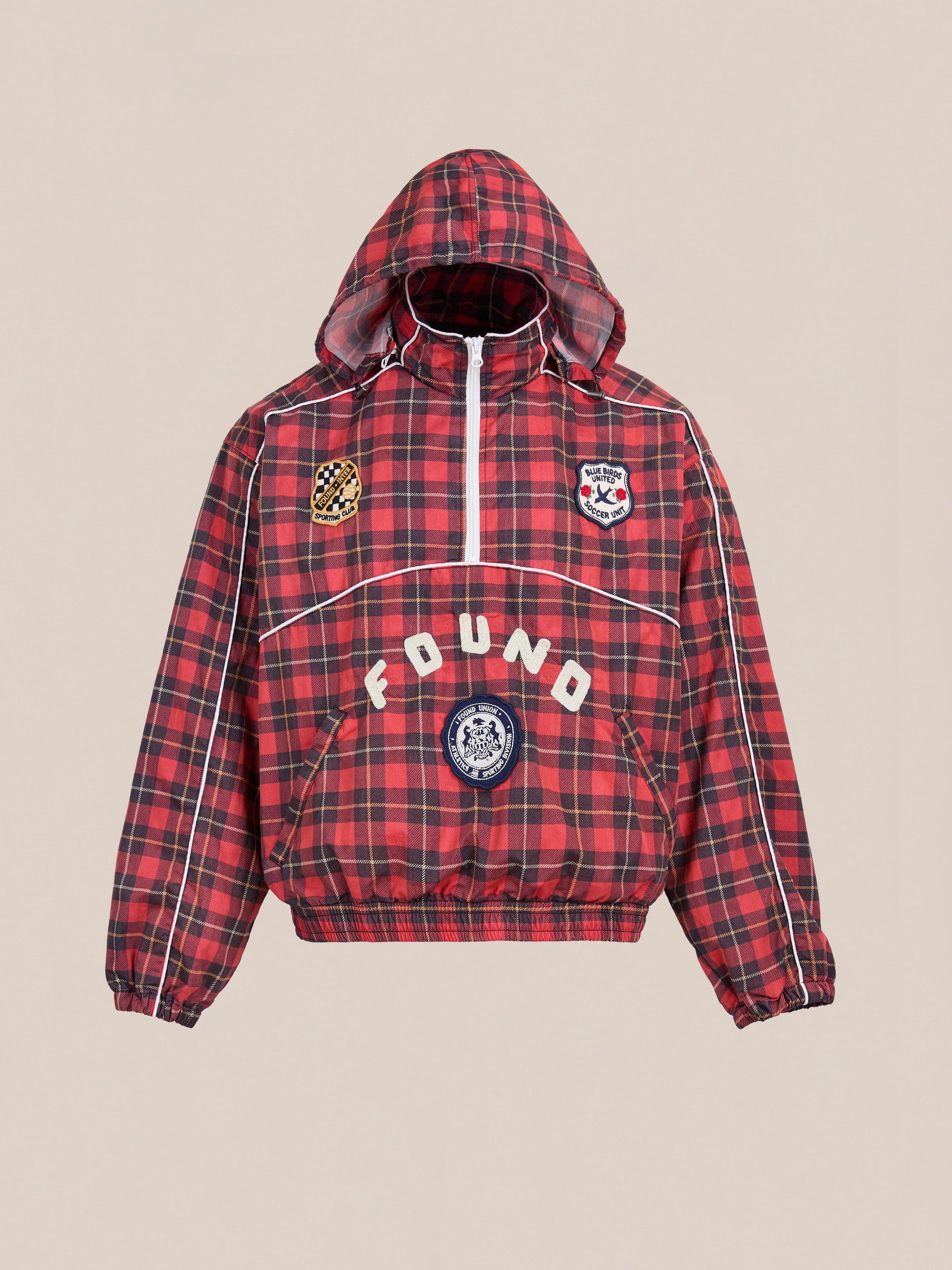 The FOUND Red Plaid Track Jacket features a red and black plaid design, white piping, embroidered patches, and "FOUND" across the front for a vintage sporty look.