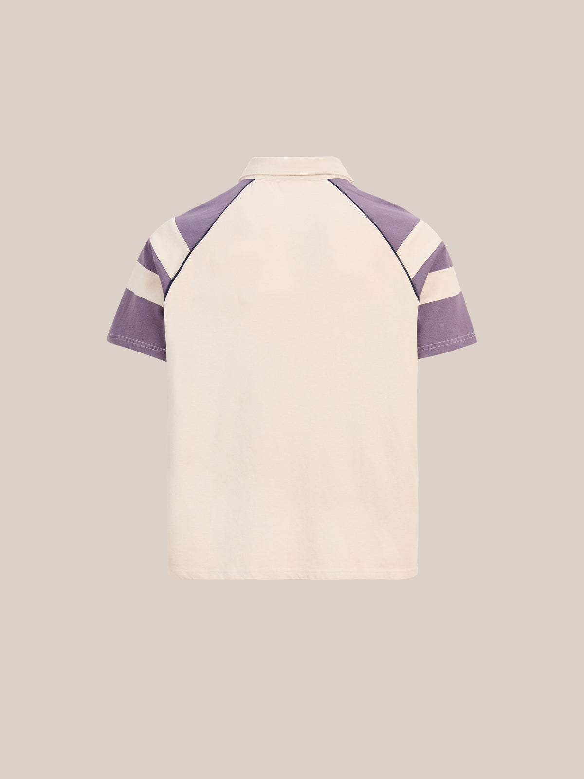 Back view of the FOUND Short Sleeve Rugby Polo with off-white body, light purple raglan sleeves, white stripes, and a unisex relaxed fit.