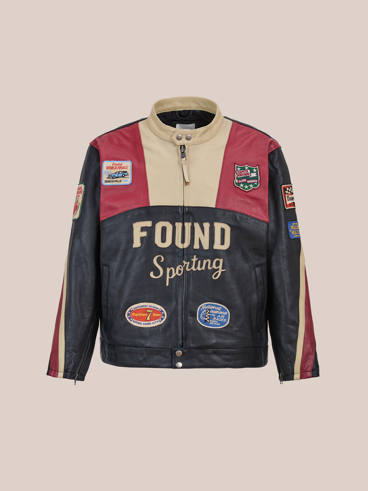 The FOUND Sport Racer Jacket features color-blocked cowhide in cream, red, and black, a zip front, stand collar, and embroidered racing patches on chest and sleeves.