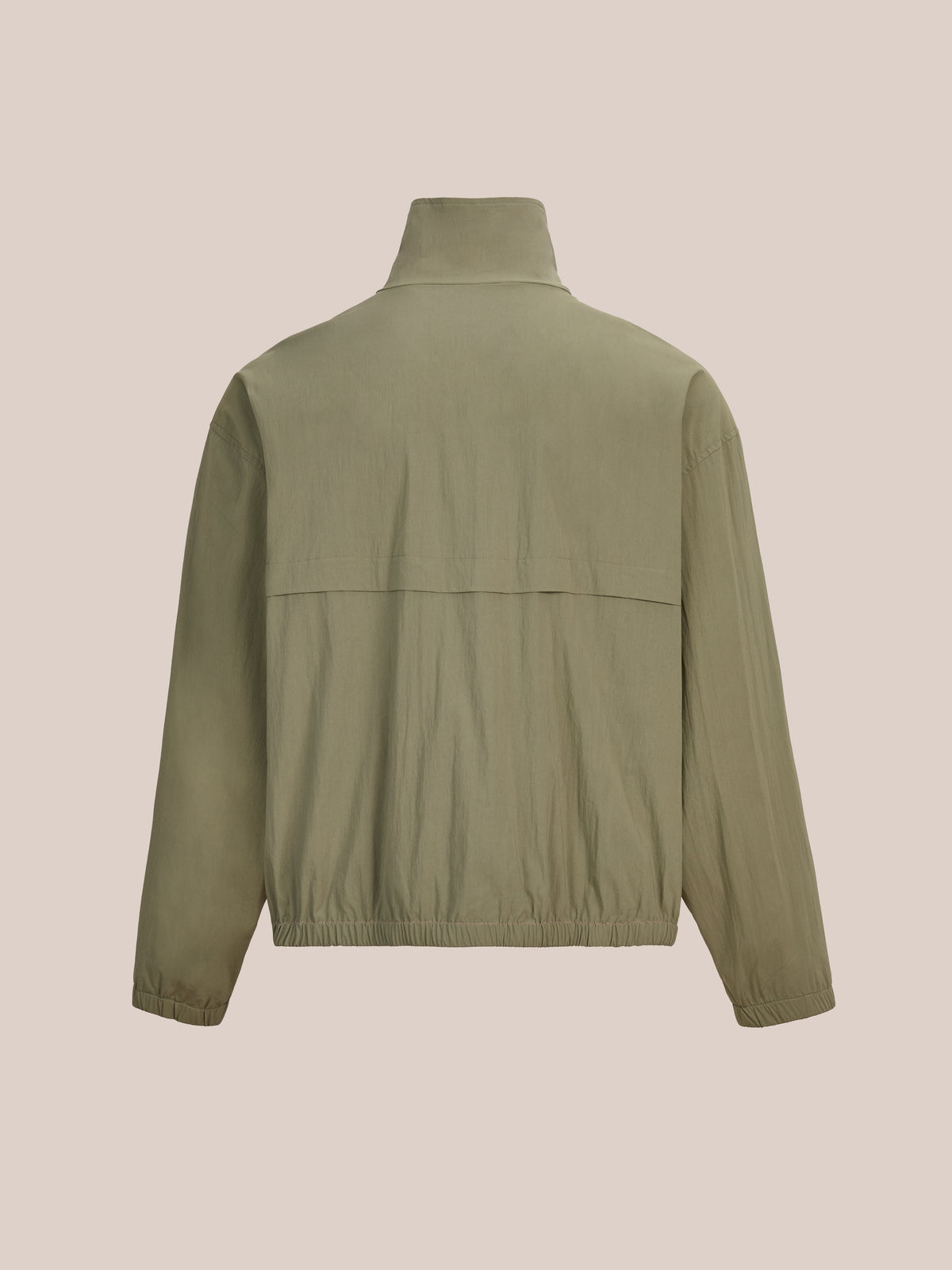FOUND Sport Windbreaker Jacket in khaki green, unisex style, shown from the back with long sleeves, high collar, and elastic hem/cuffs on a beige background.