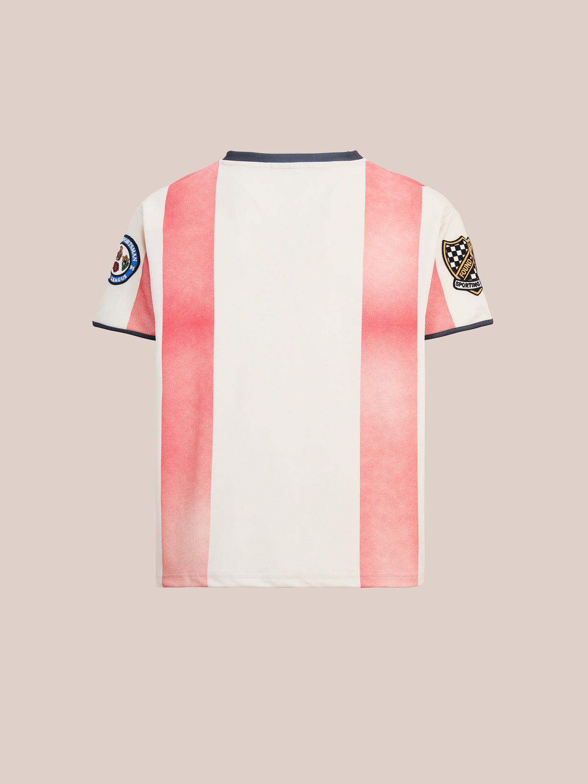 Back view of the Striped Stateman Jersey by FOUND, a unisex sportswear item with bold red and white vertical stripes and two embroidered sleeve patches, inspired by vintage football jerseys, shown on a plain beige background.