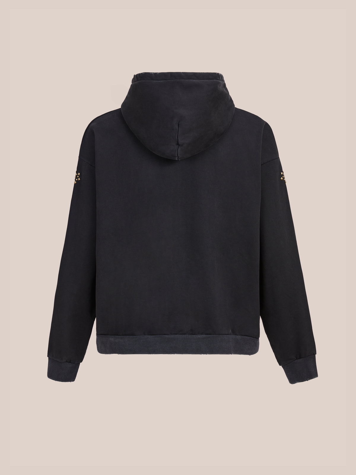 The Studded Zip Up Hoodie by FOUND is shown from the back, with long sleeves and subtle studs on the upper arms, set against a plain beige background.
