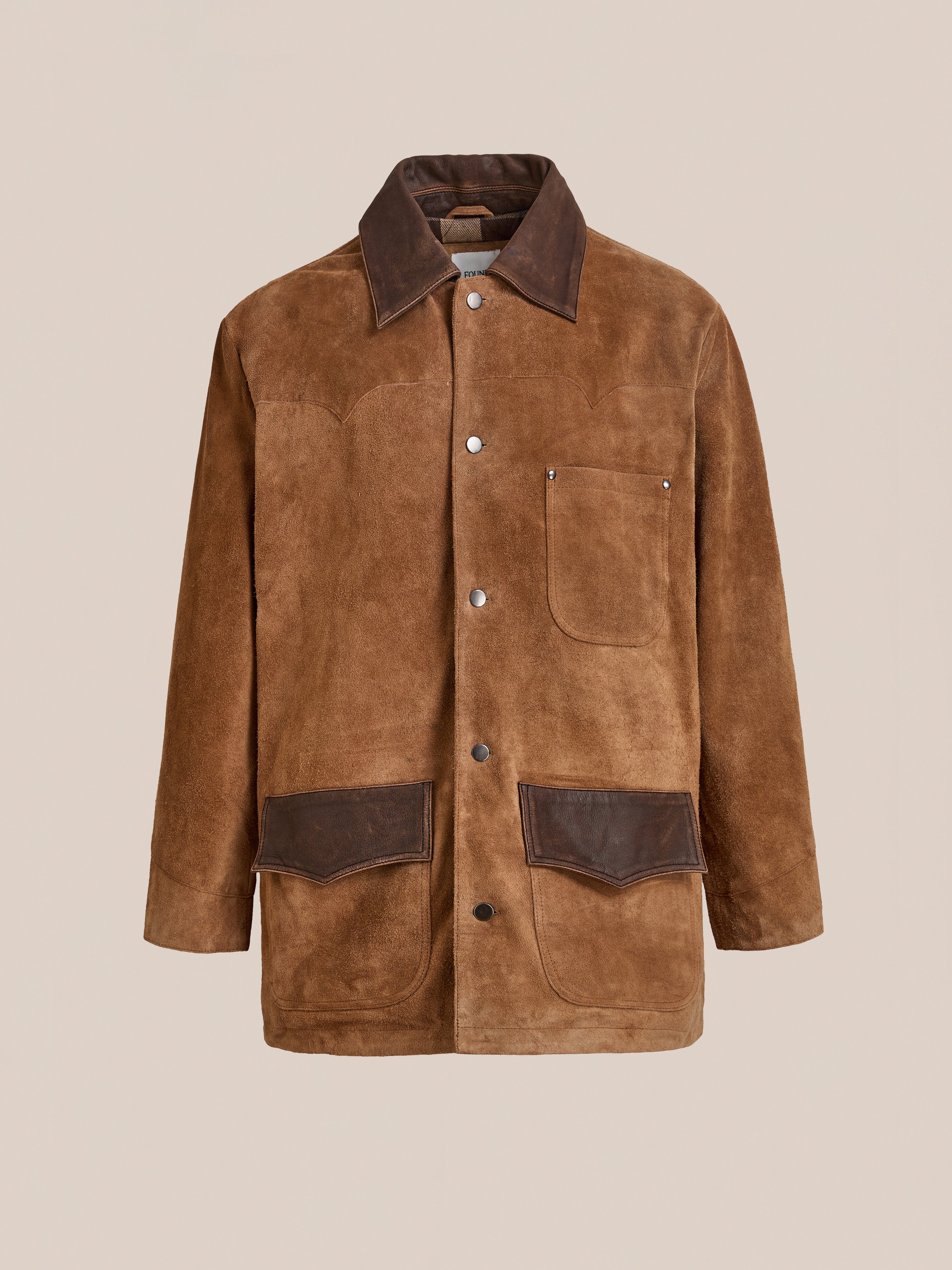 FOUND Suede Contrast Chore Jacket in brown vintage suede, featuring a dark brown collar, pocket flaps, three front pockets, and snap button closure, shown against a plain beige background.