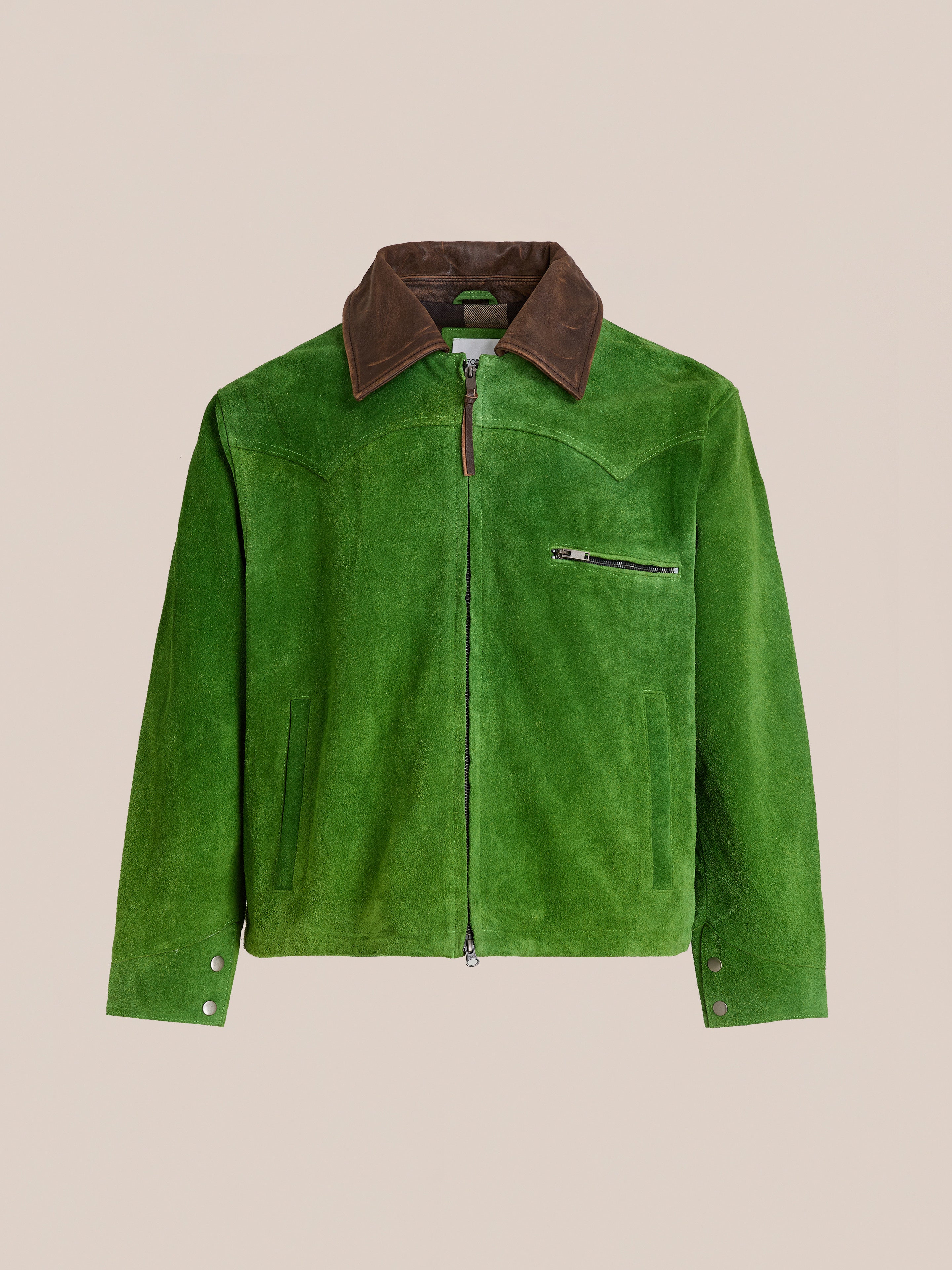 The FOUND Suede Western Barn Jacket features green genuine suede leather, western yoke stitching, a front zipper, brown collar, zip chest pocket, two side pockets, and buttoned cuffs. Shown on a plain beige background.