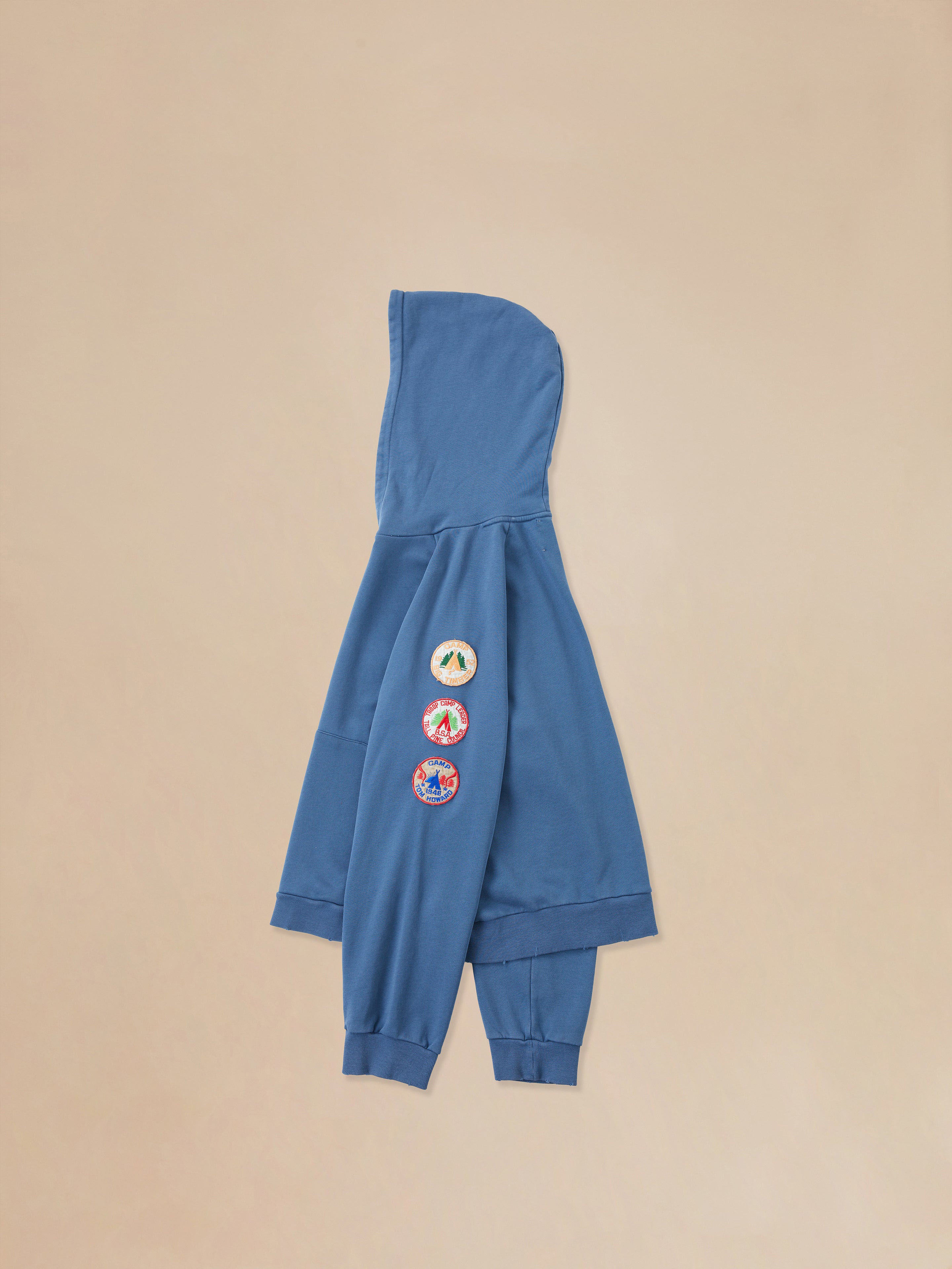 A Timber Campground Hoodie by Found with patches on it.