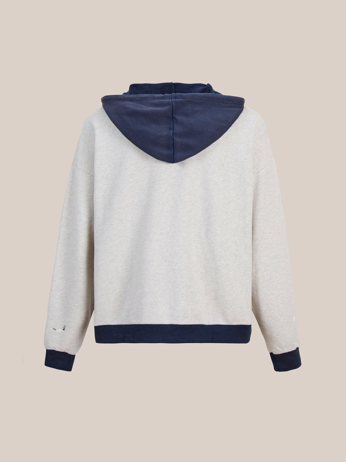 Back view of the FOUND Two-Tone Painter Hoodie, featuring a light gray body with contrasting navy blue hood, cuffs, and waistband, displayed against a plain beige background.
