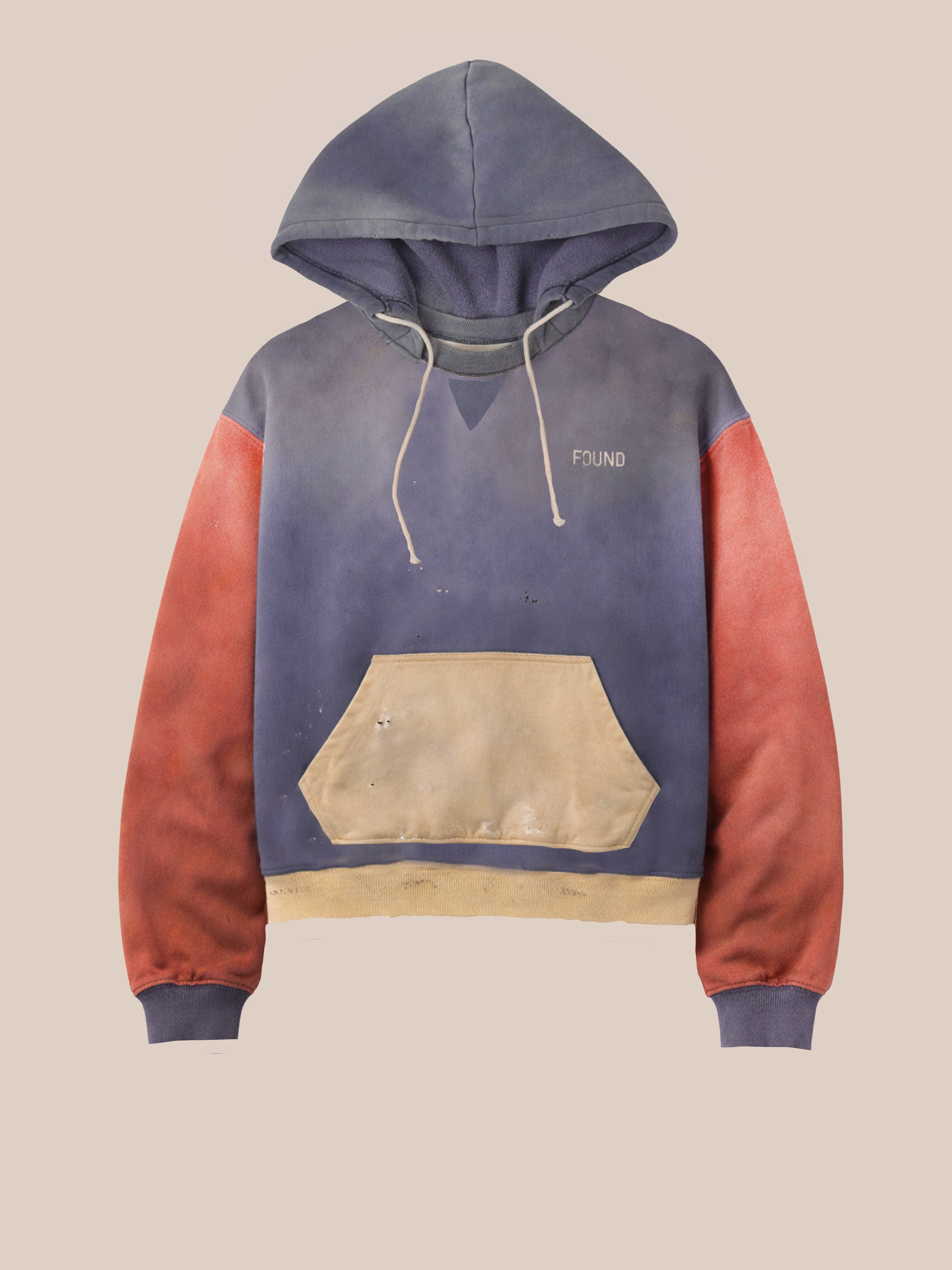 The FOUND Two-Tone Painter Hoodie is a unisex, relaxed fit hoodie with a blue hood/body, red sleeves, tan pocket/hem, visible paint stains, and "FOUND" embroidered on the chest. It features a unique color-blocked design.
