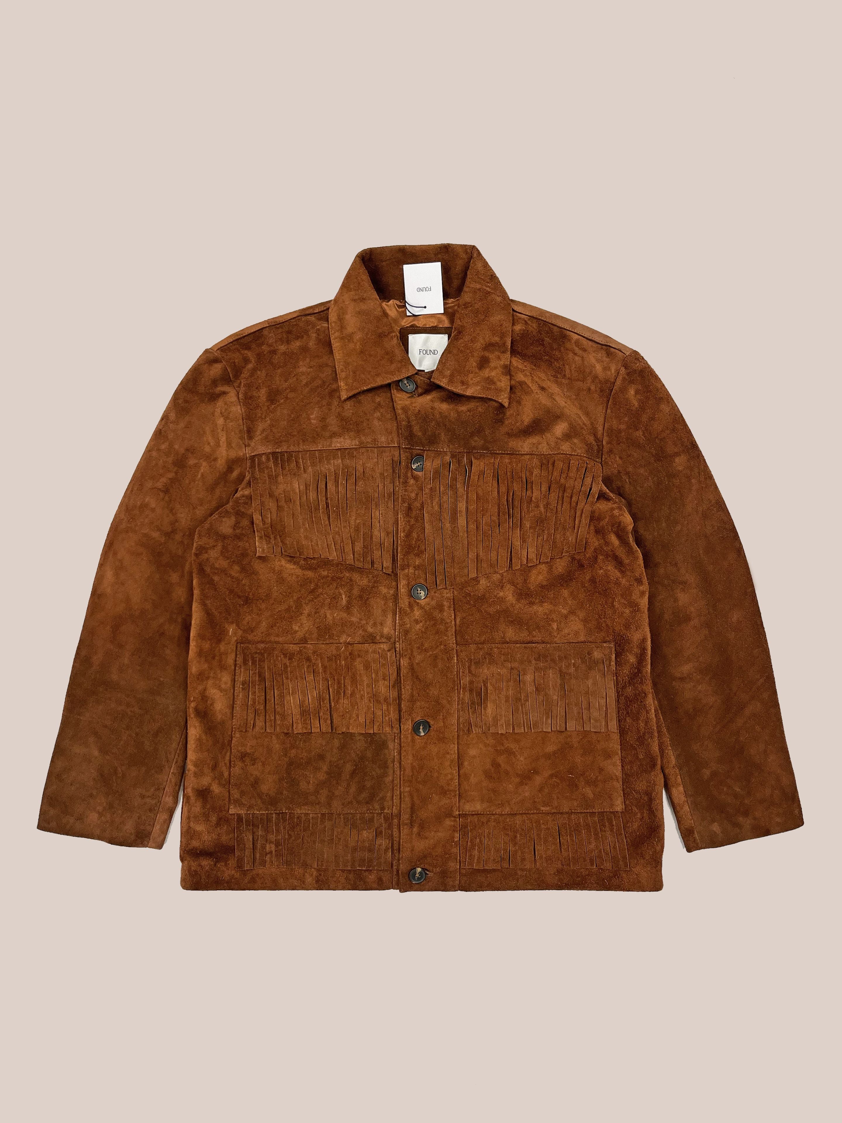 FOUND Western Suede Fringe Jacket in brown suede features a button closure, fringe detail on the chest and pockets, and a collar, shown laid flat on a neutral background.