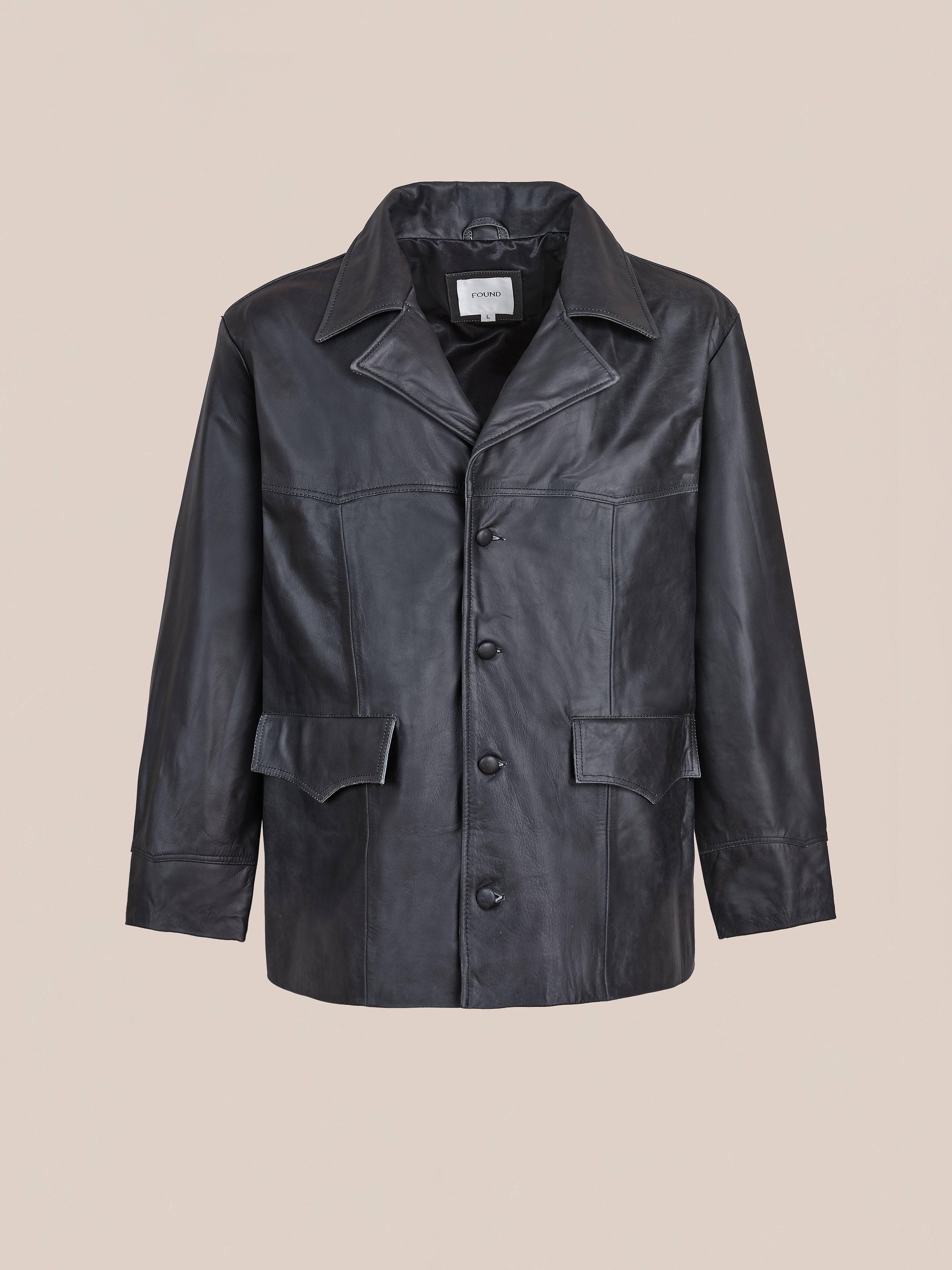 The FOUND Western Oversized Leather Blazer features a classic collar, front button closure, flap pockets, and long sleeves, shown on a plain beige background.