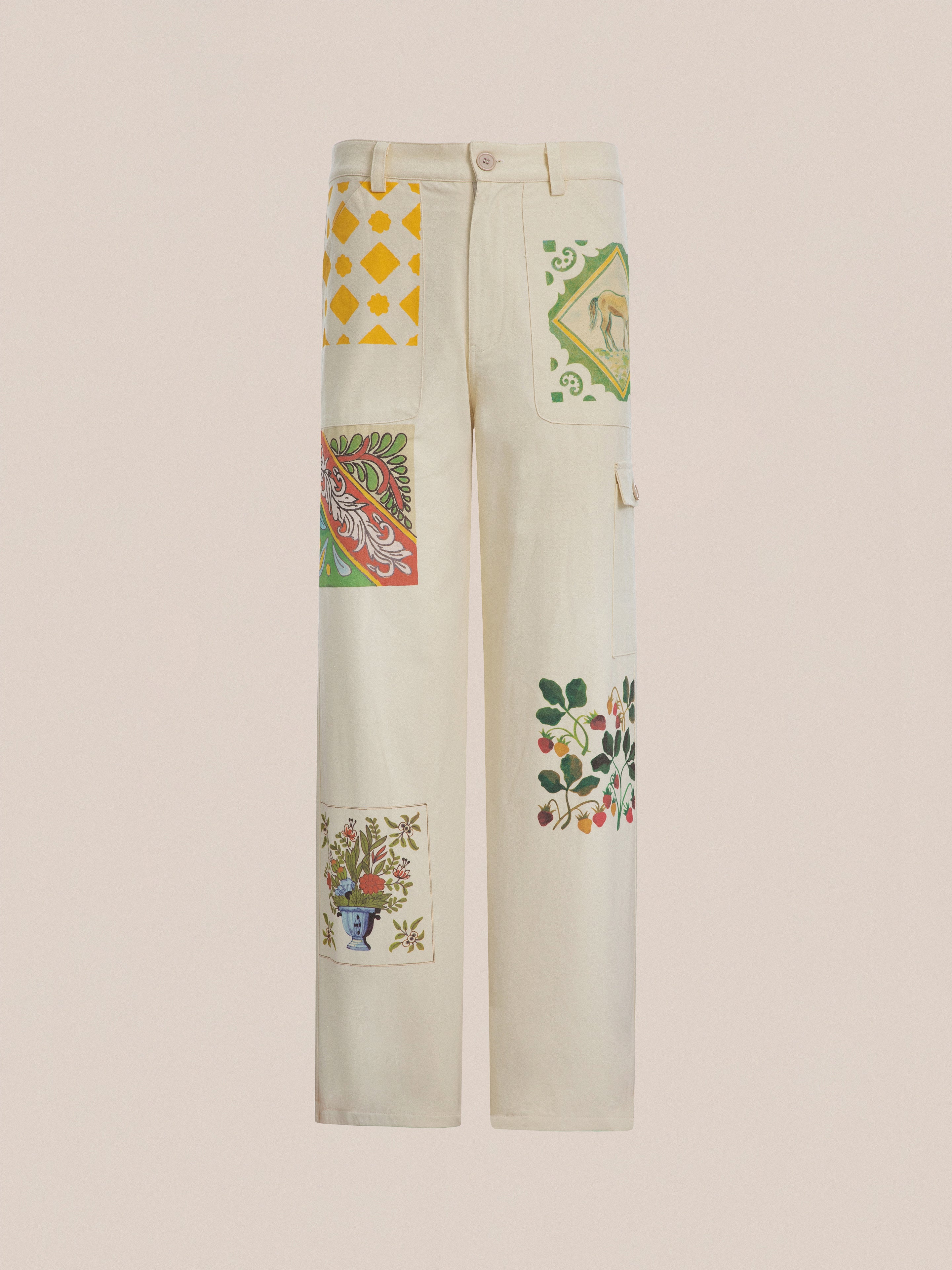 The unisex Mosaic Pants from FOUND feature a straight-cut design in cream with vibrant floral and geometric Indo-Aryan patchwork patterns.