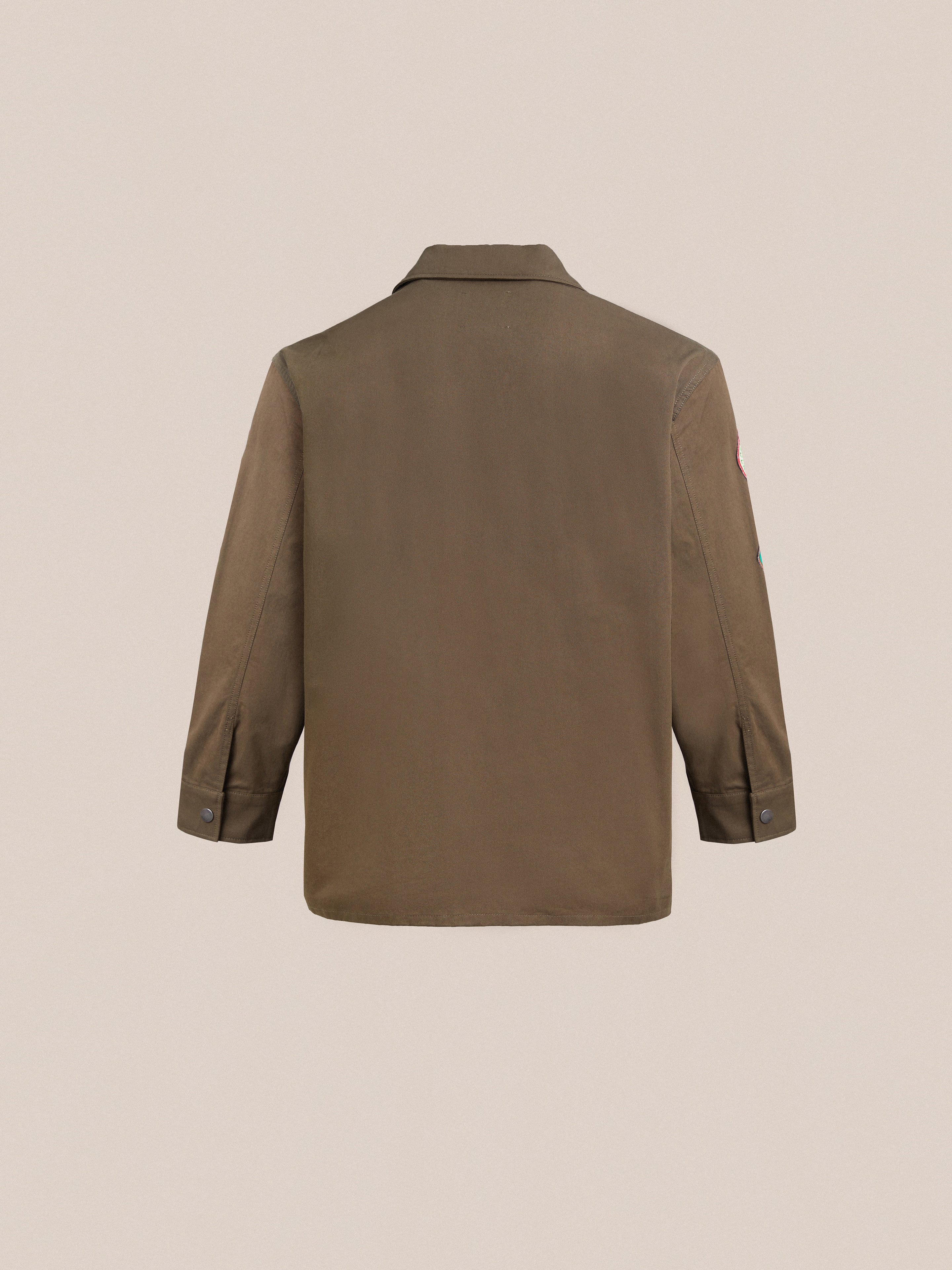 The back view of a Found Ports Park Multi Patch Work Jacket, featuring embroidered patches, on a white background.