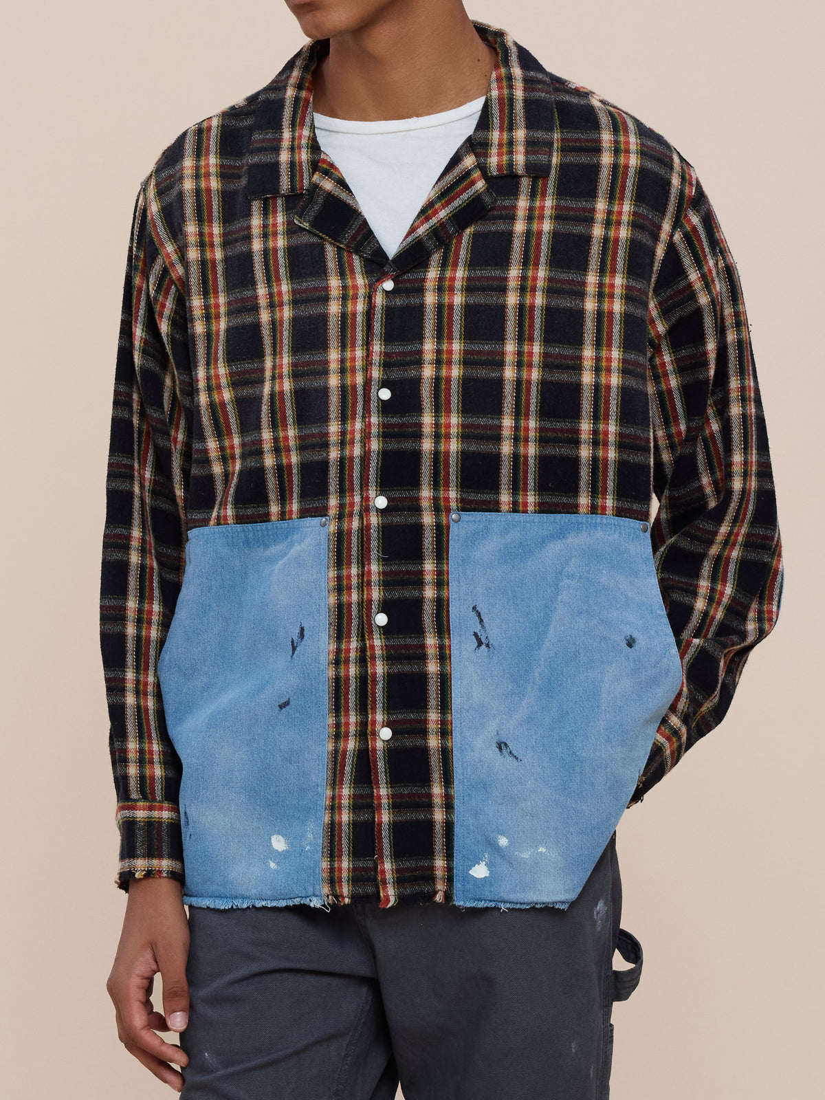 A person wearing the FOUND Plaid Denim Shirt with blue distressed denim patch pockets over a white t-shirt and dark gray pants.